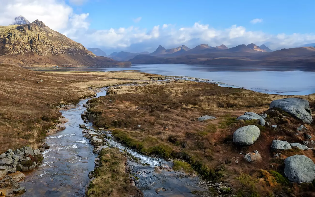 Shot of a stream in the Isle of Skye next to a lake.