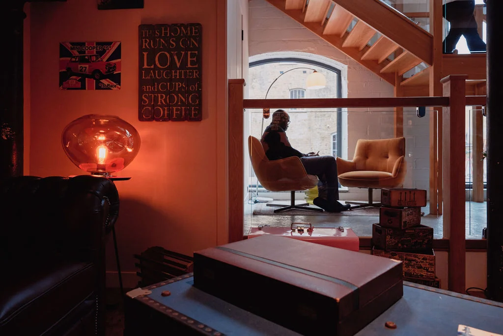 The lounge corner at Drop-in Wandsworth, lamps on