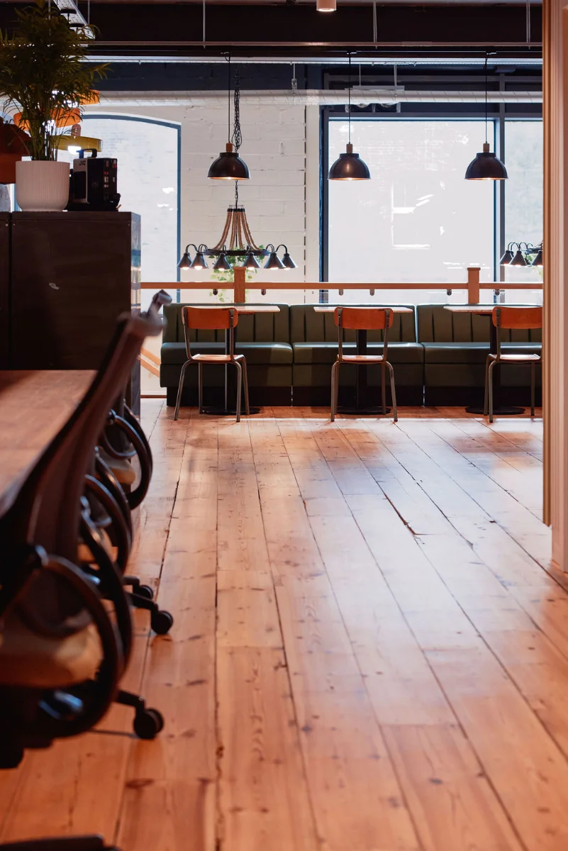 Café banquettes and original wood floors at Drop-in Wandsworth