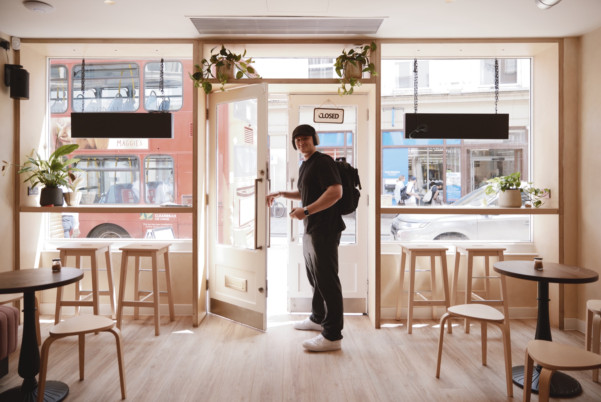 Inside the Drop-in Richmond caf&eacute;, a red London bus passing on George Street, TW9
