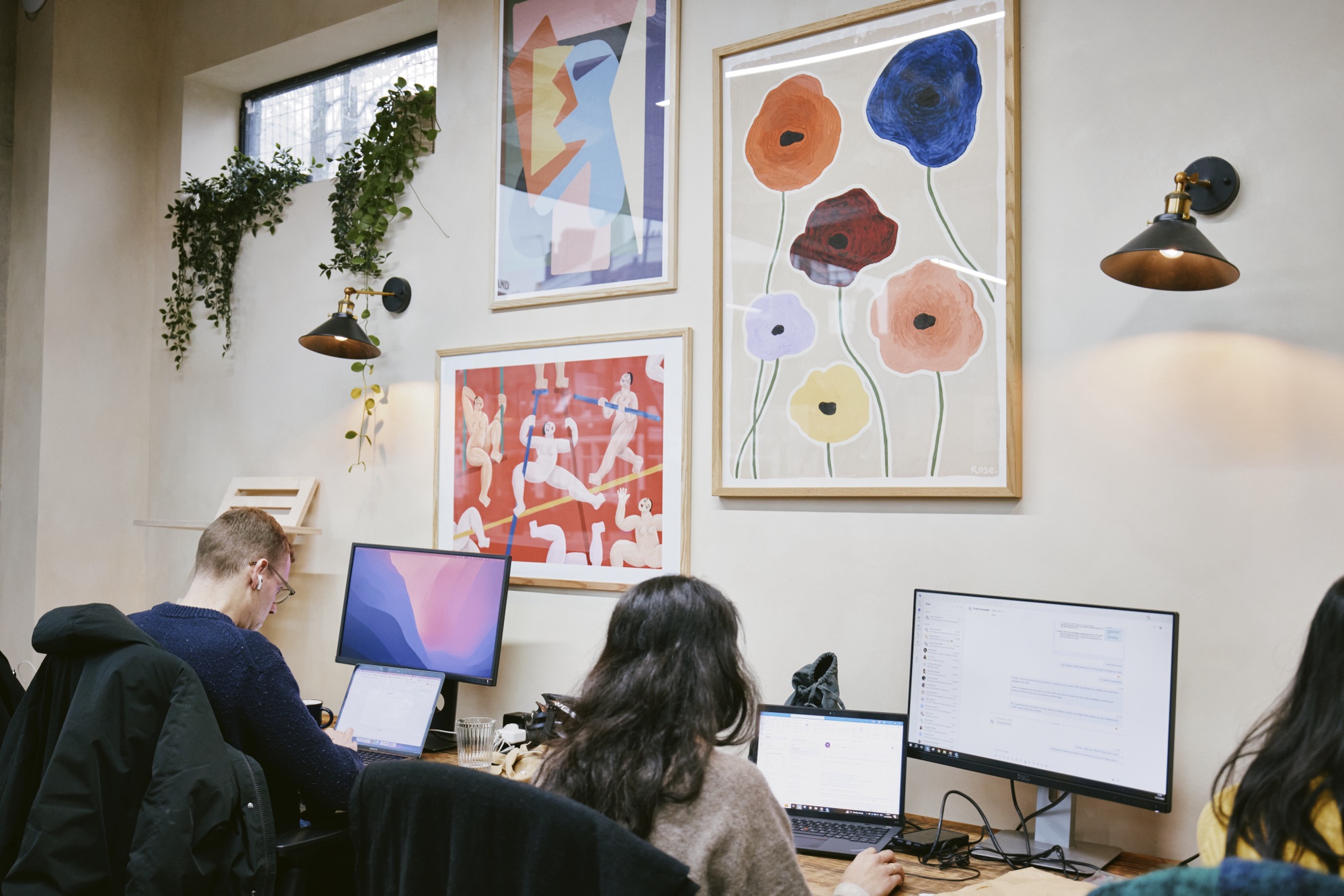 The coworking floor at Drop-in Clapton, with art prints and plants, E5