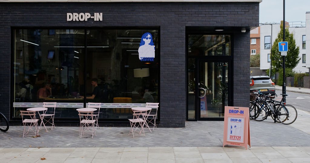 The Drop-in Clapton shopfront with pink cafe tables outside