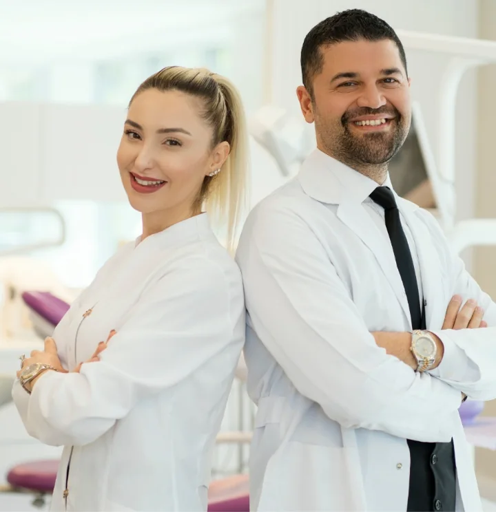 a man and a woman in lab coats standing back to back