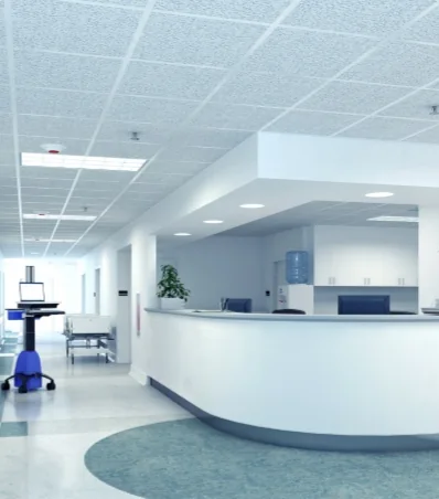 a hospital waiting room with a desk and a chair