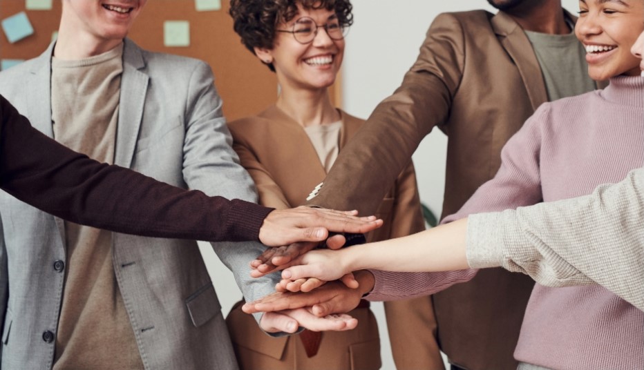 a group of people holding their hands out