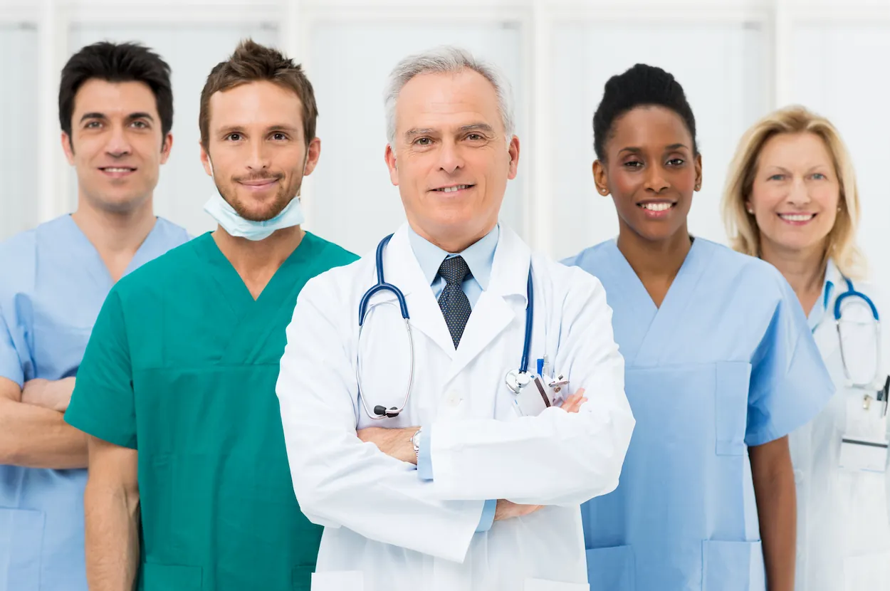 A group of doctors and nurses posing for a photo