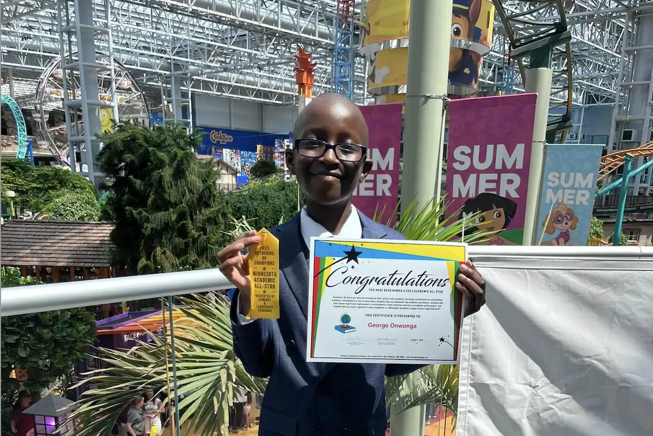A boy holding a certificate.