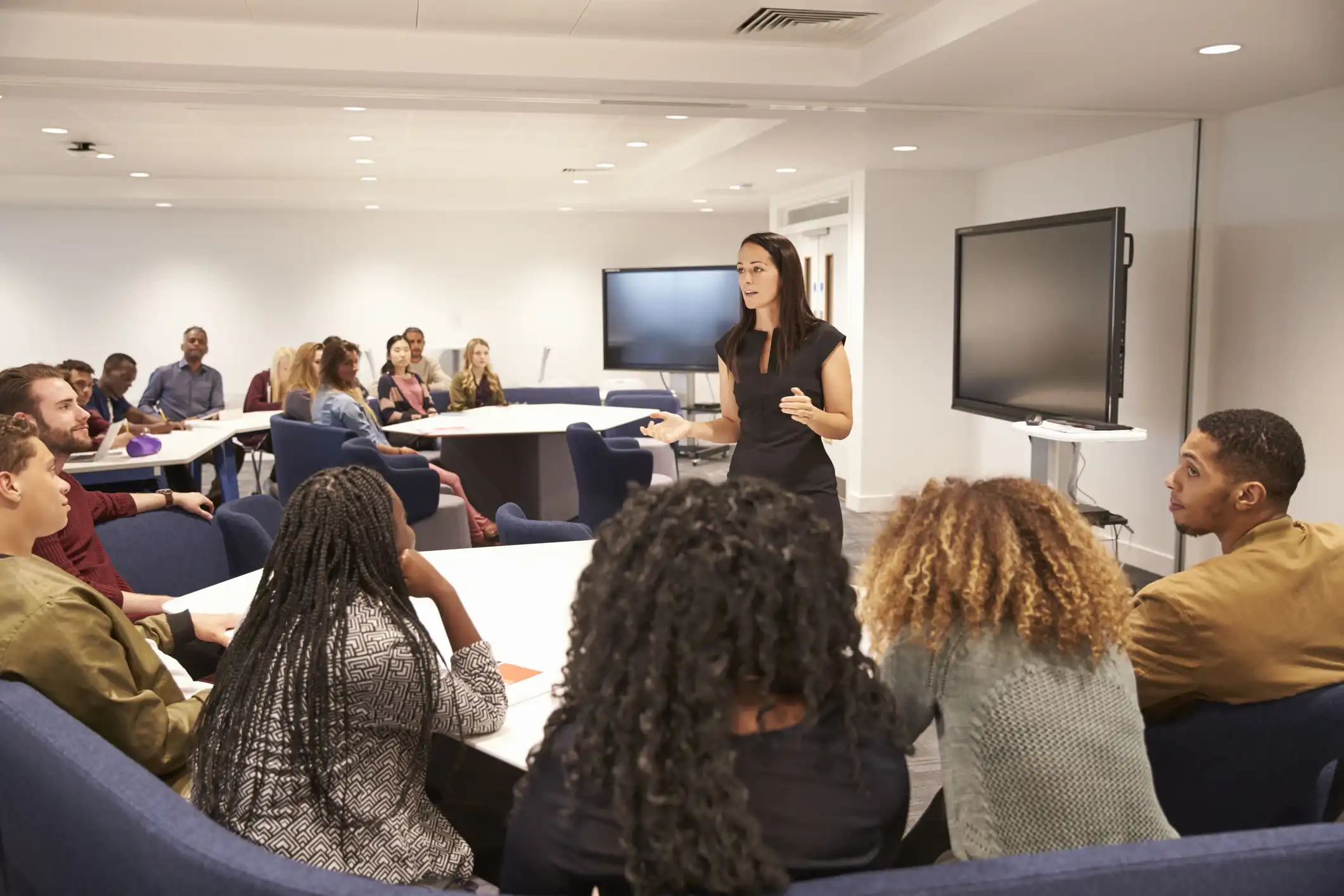 Teacher standing in front of a group of teachers in a professional development session
