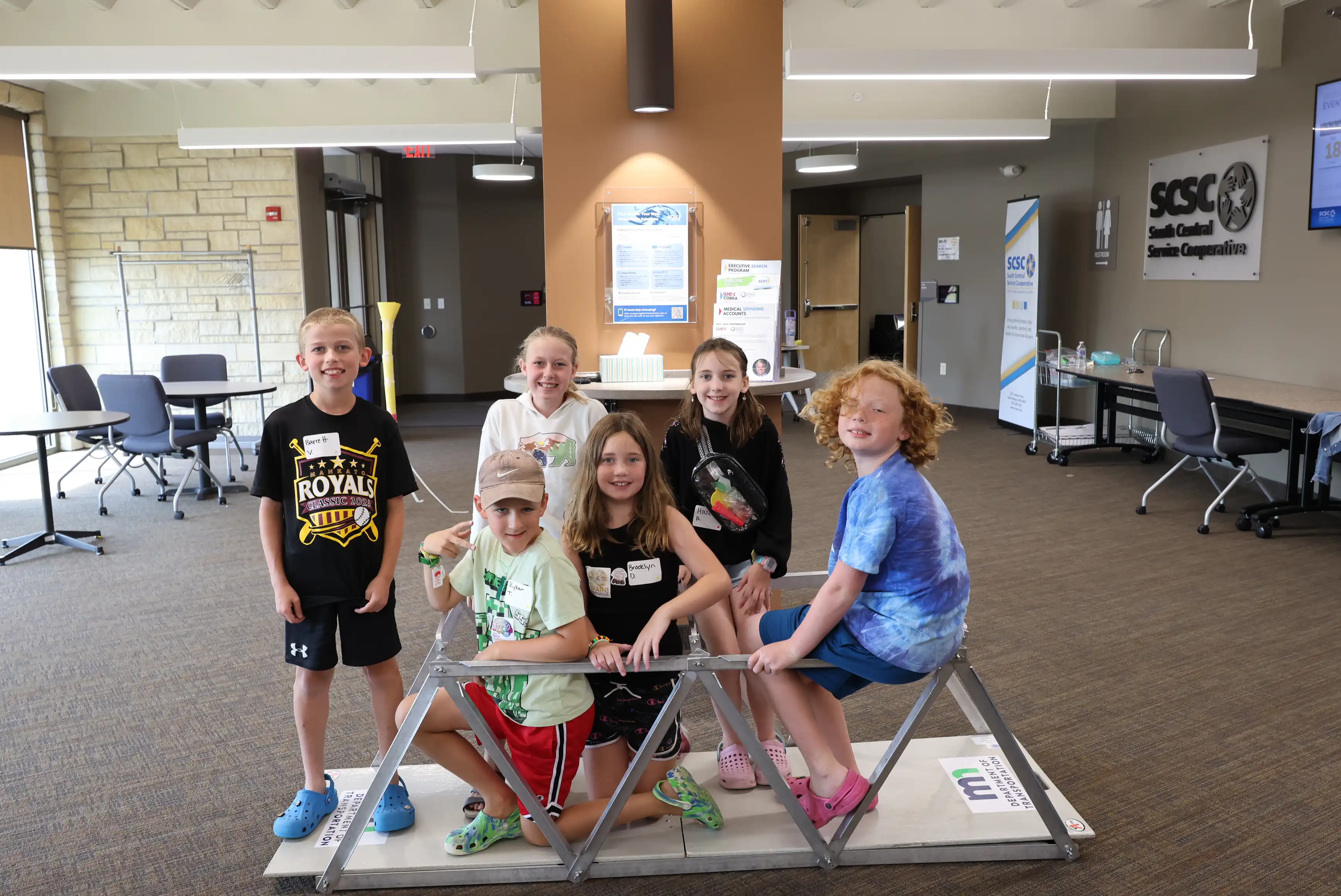 students posing around the bridge they built