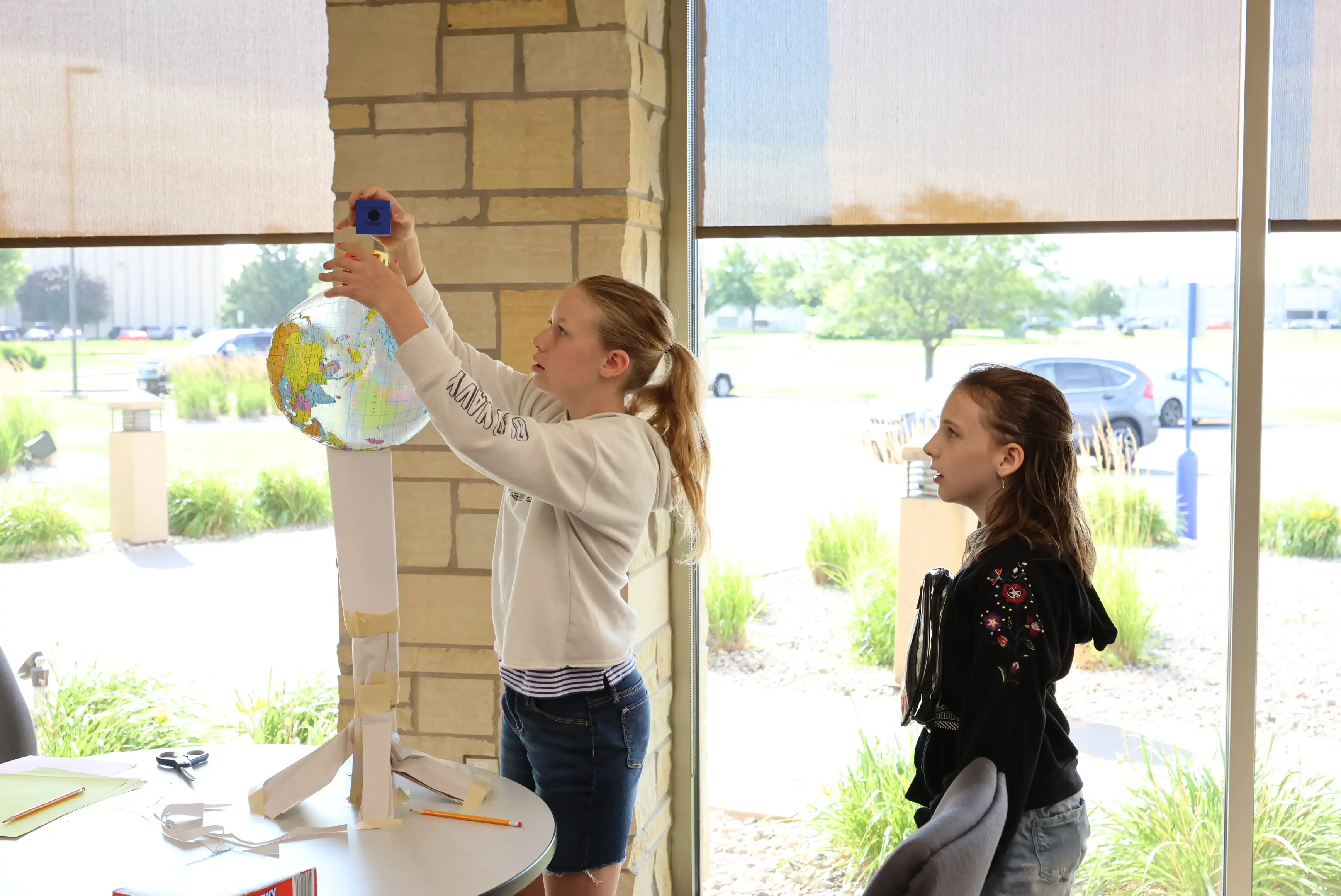 students looking at a globe