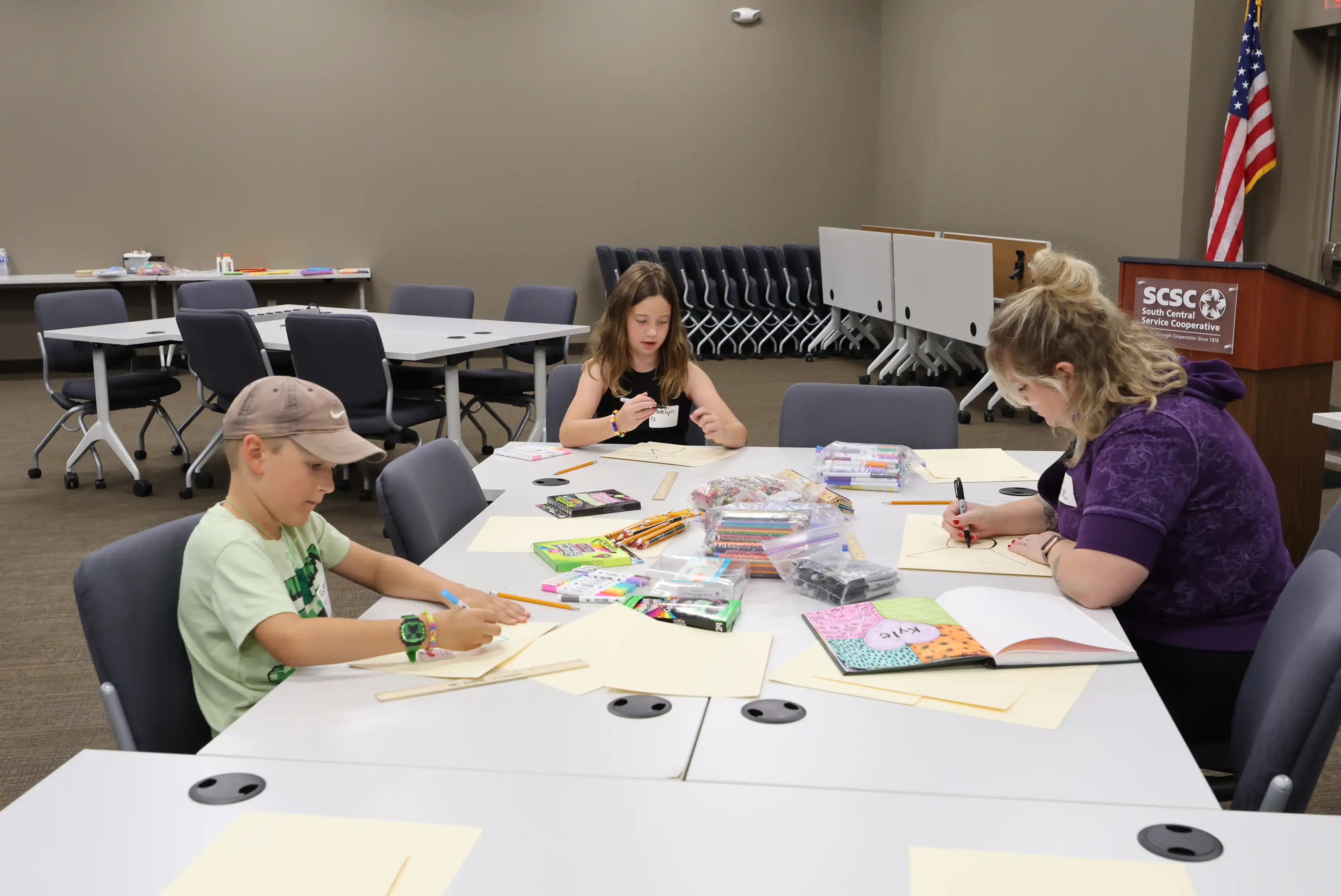 Students working at a table on their projects