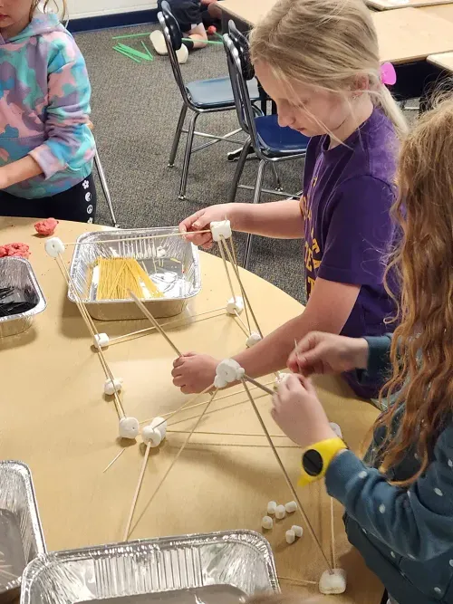 student building with sticks and connectors