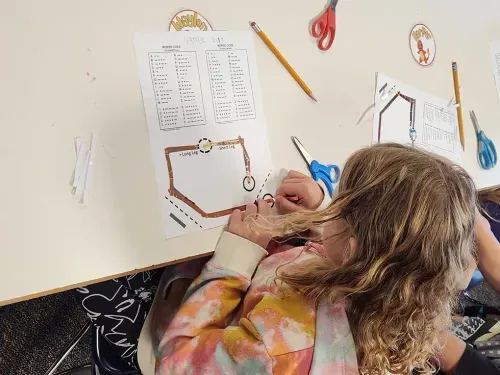 student working on worksheet of math problems