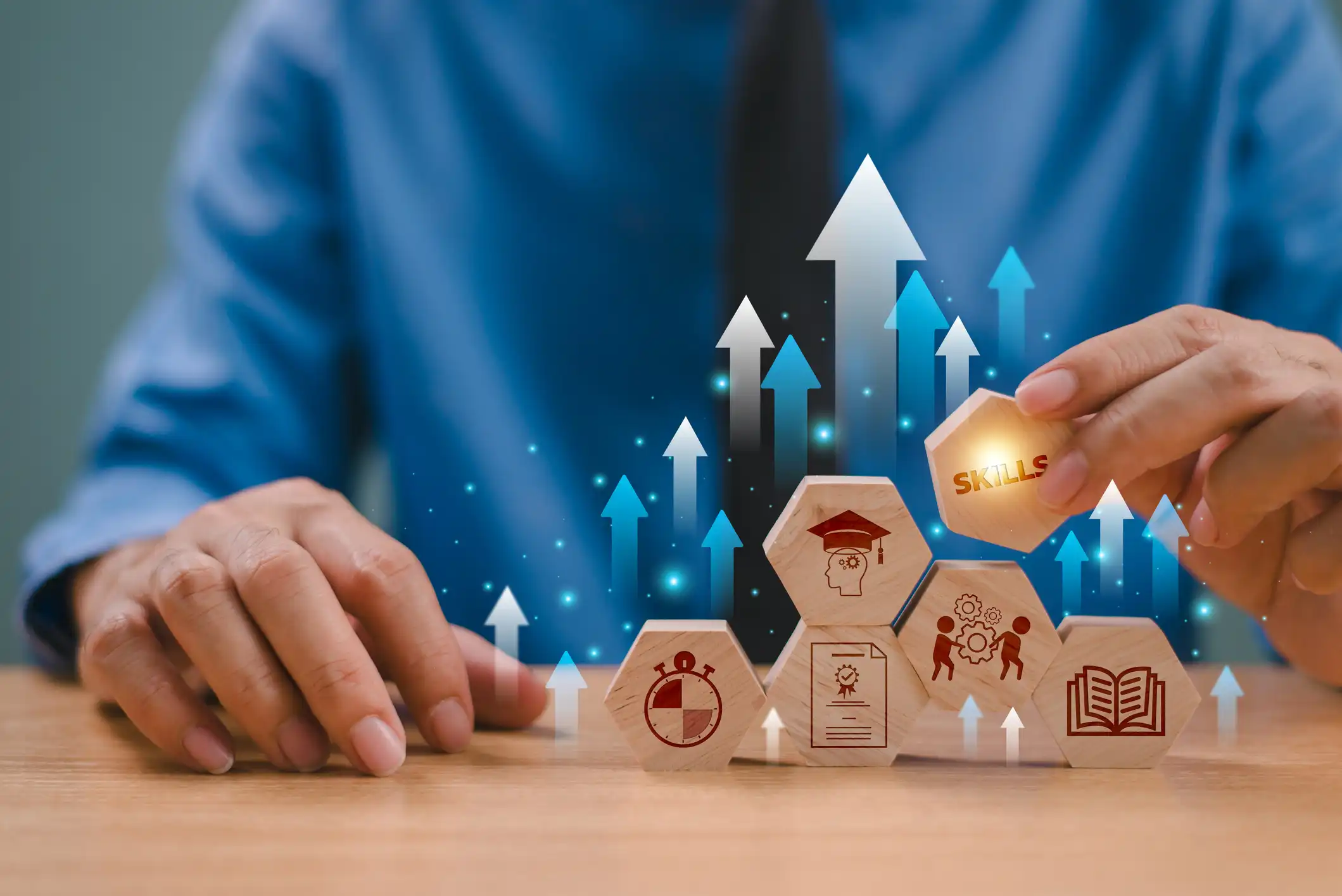 person moving various beehive shaped tiles with icons showing a booking, graduation hat, skills and more that show the various steps you need to take to start your career
