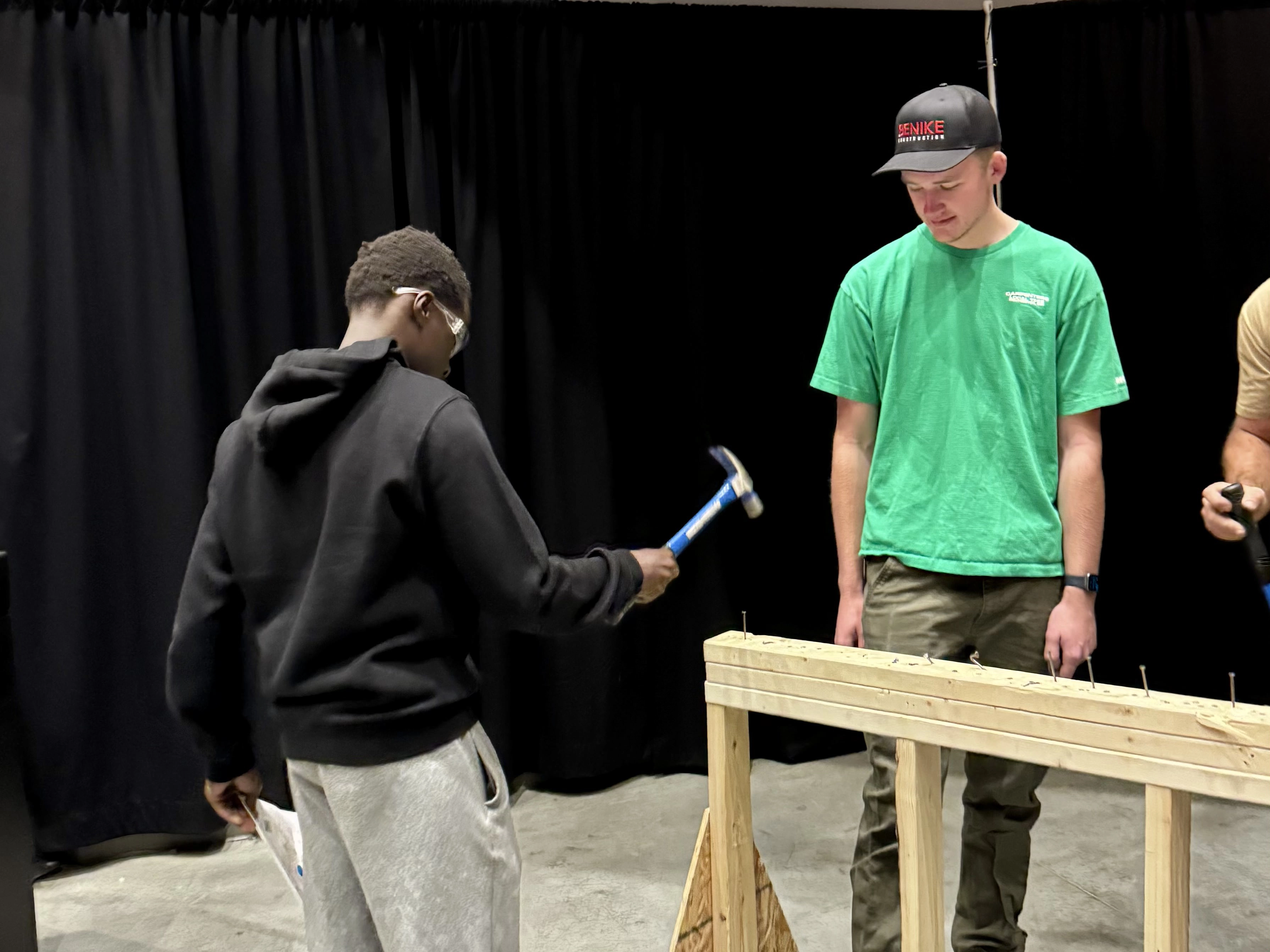 Student pounding nails into a board.