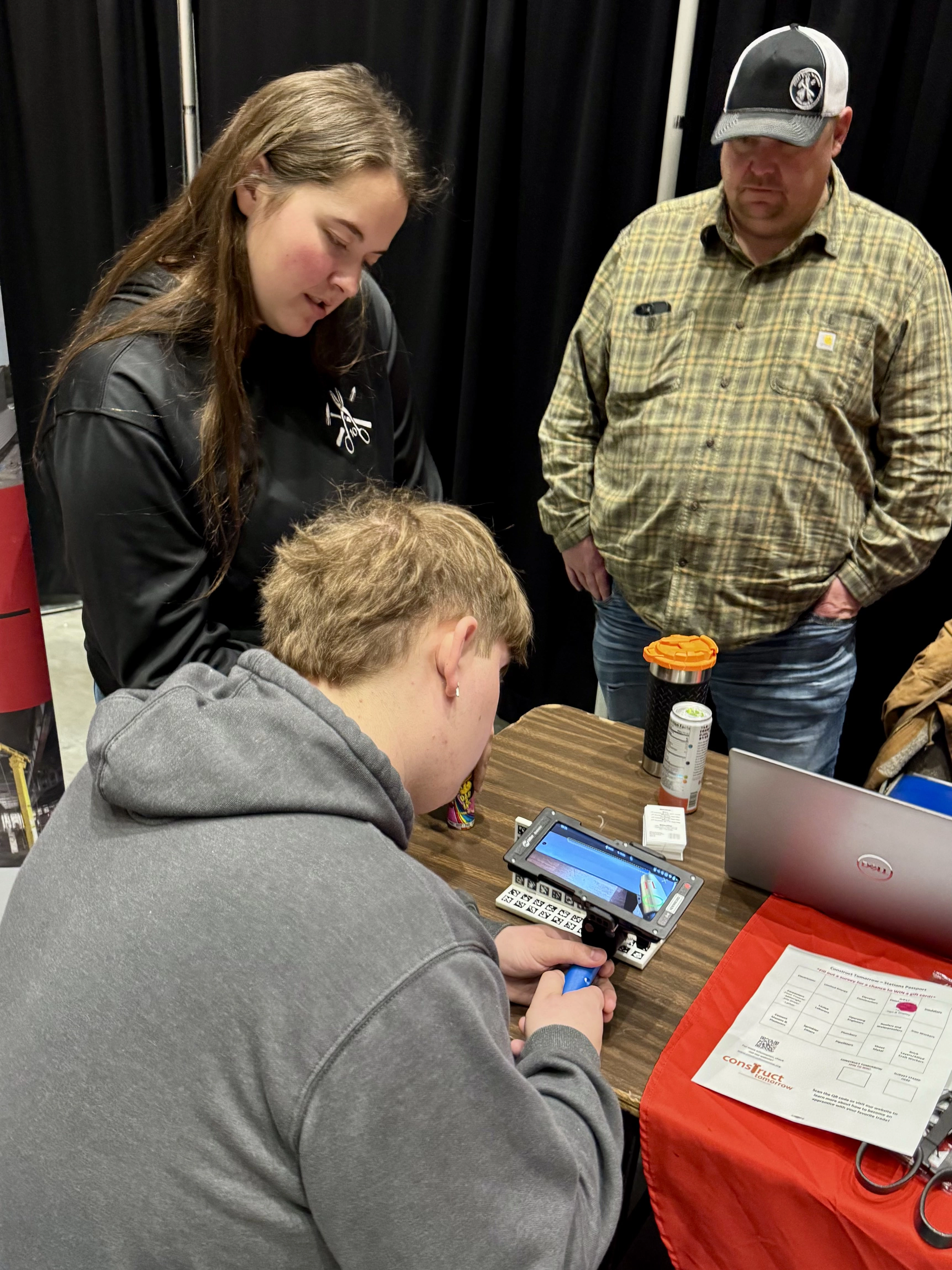 Students at a booth learning about a trade