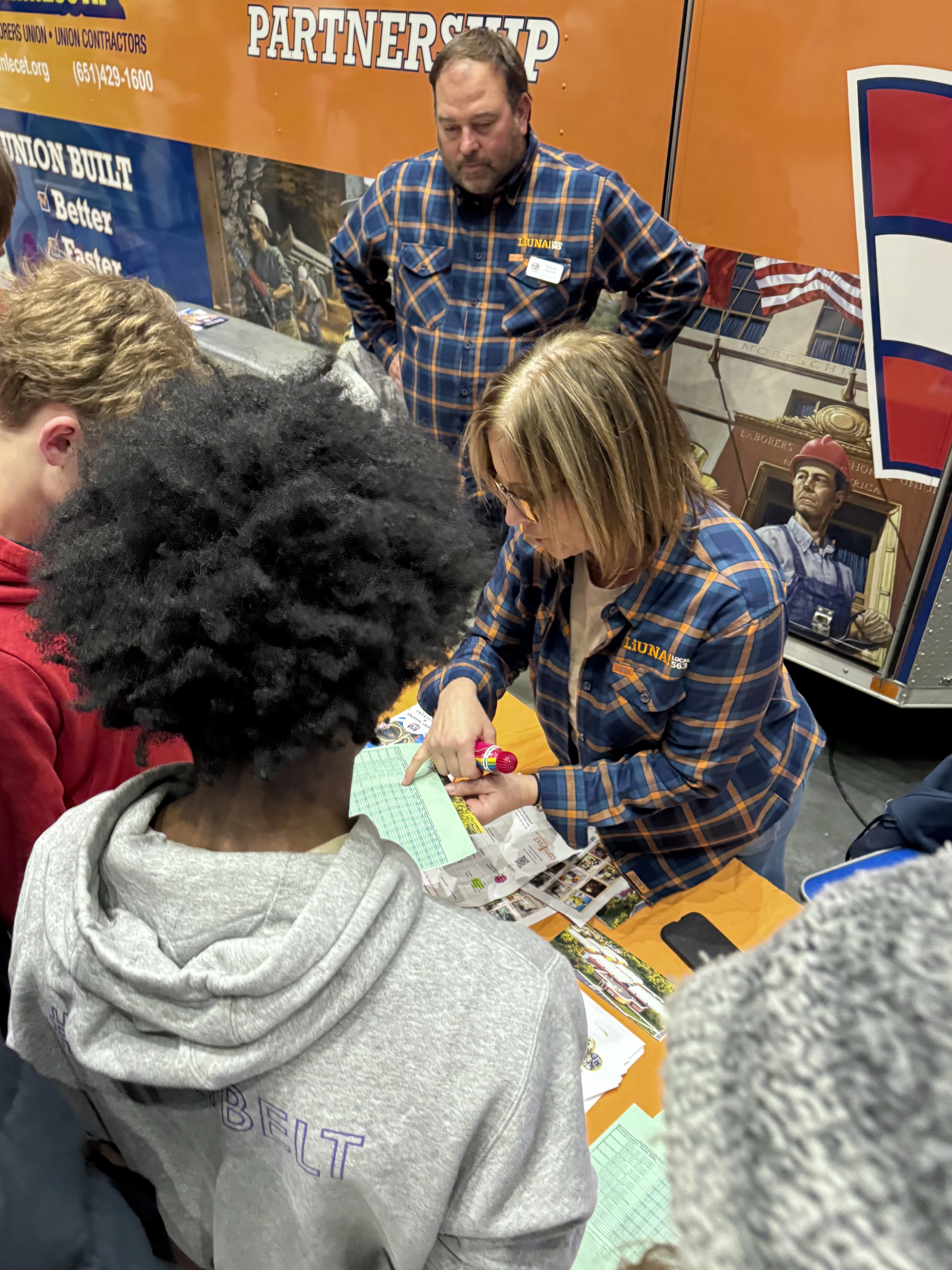 Students at a booth learning about a trade