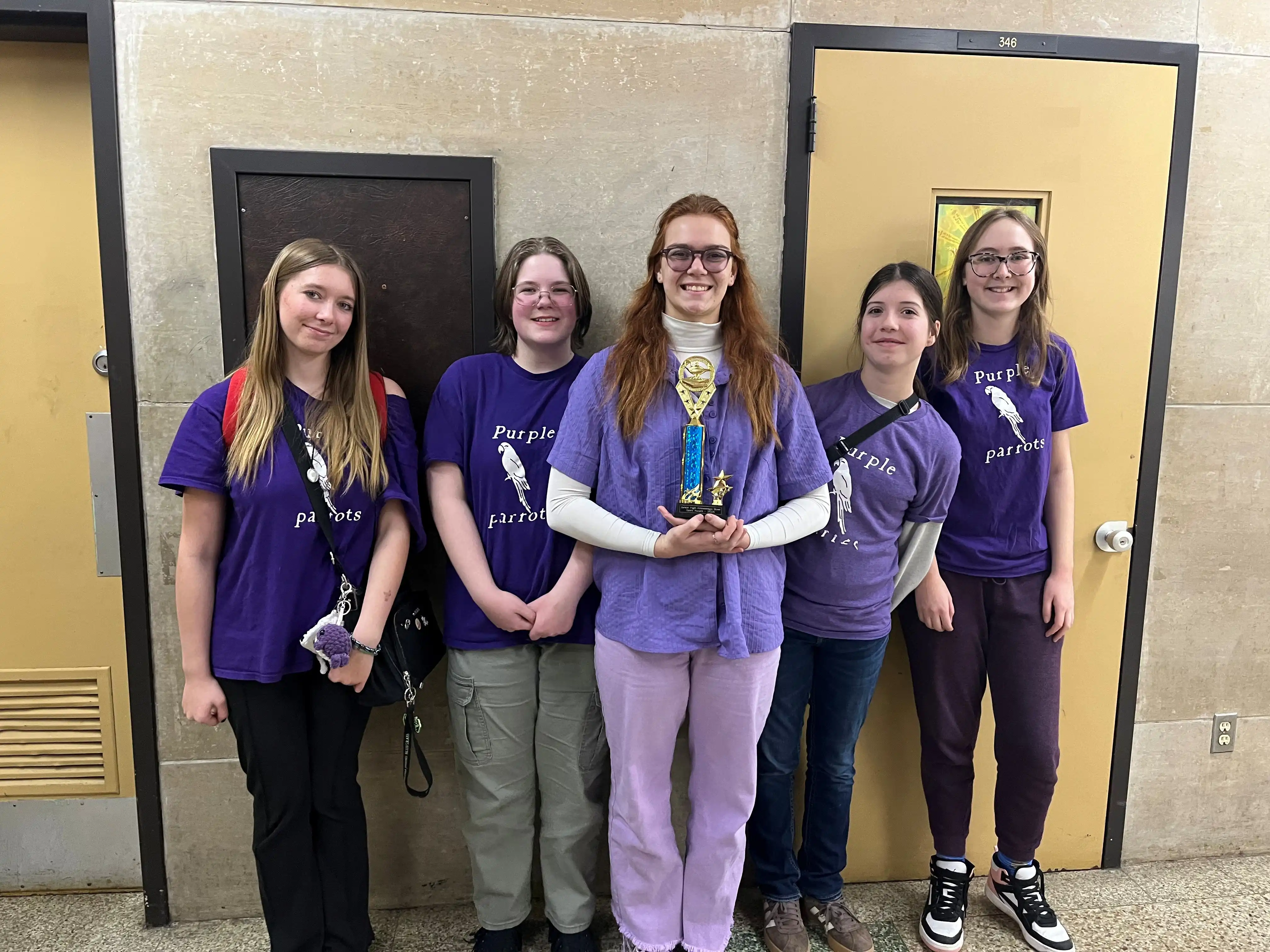 St. Clair Purple Parrots team members holding their spirit award trophy