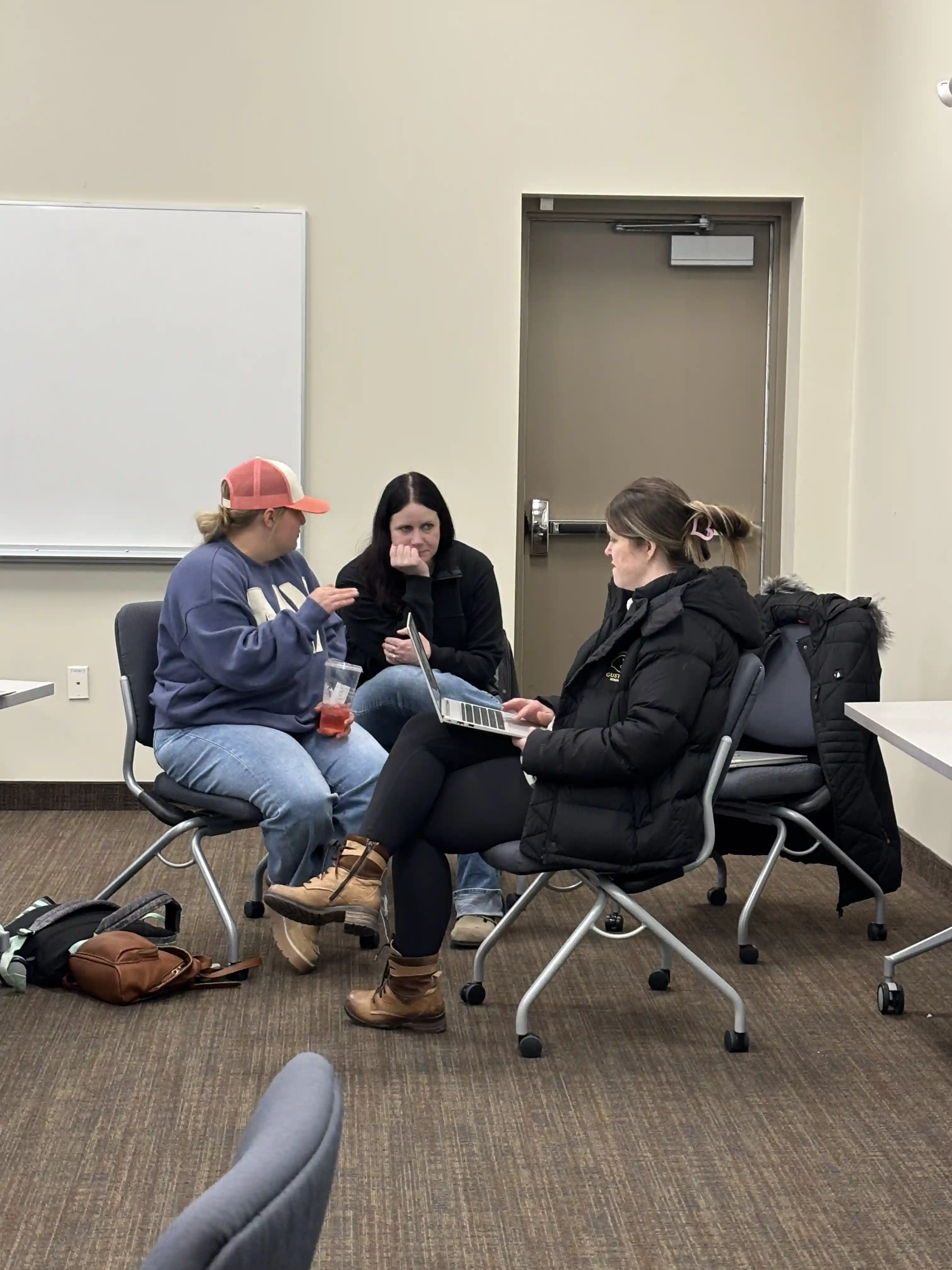 three educators in a circle with their chairs 