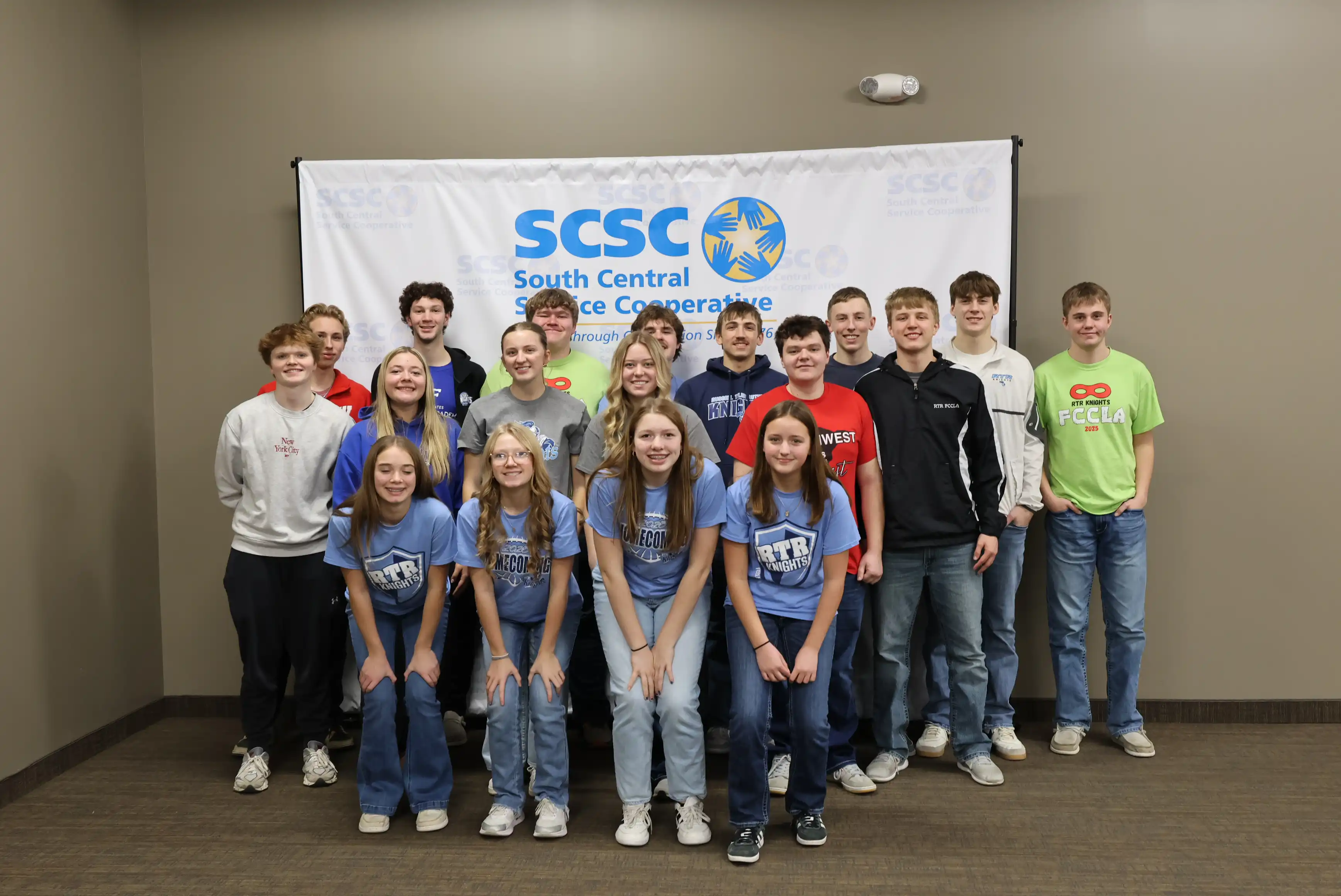 All student participants in a large group in front of SCSC sign
