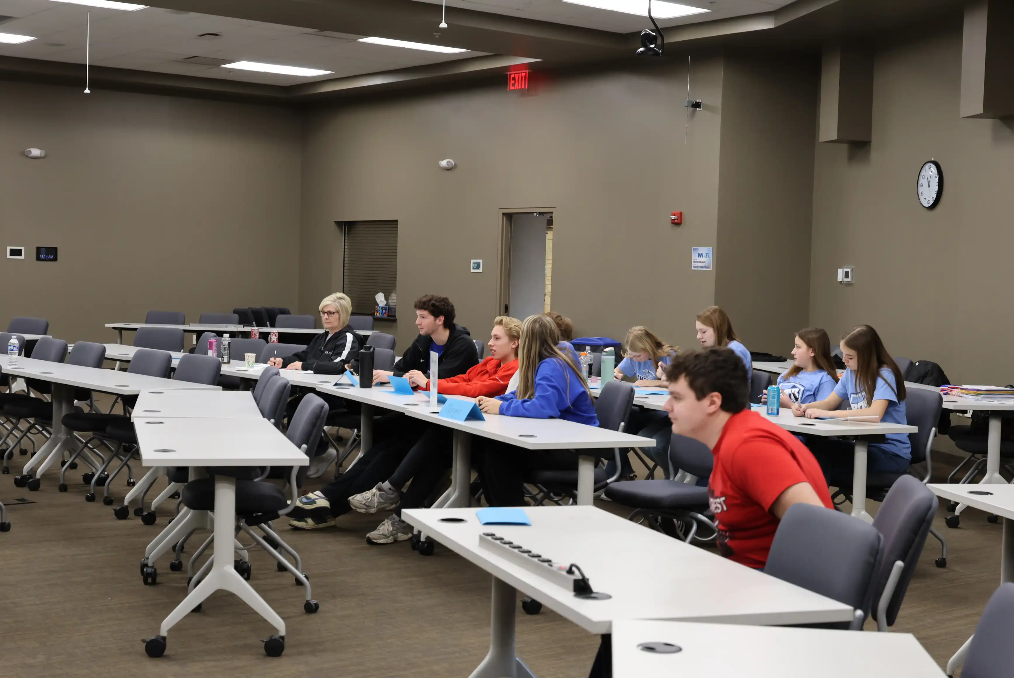 students sitting in various rows at tables
