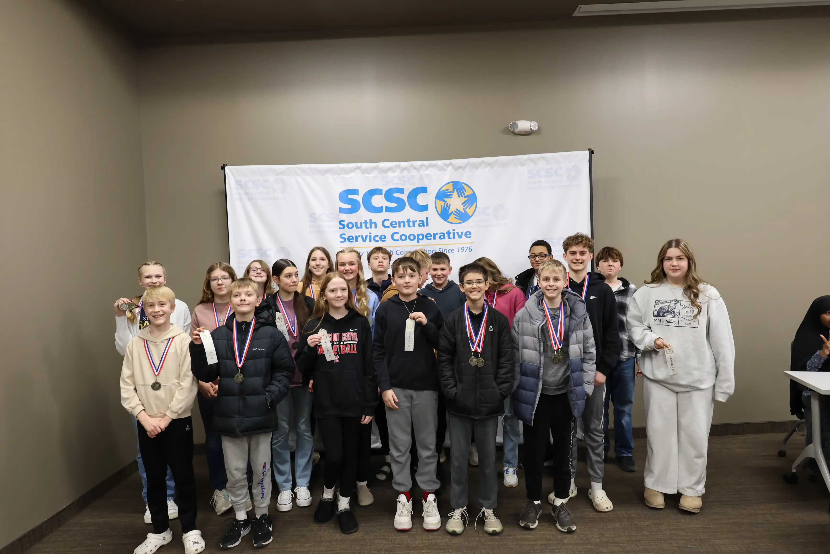 winners all gathered together smiling for a picture