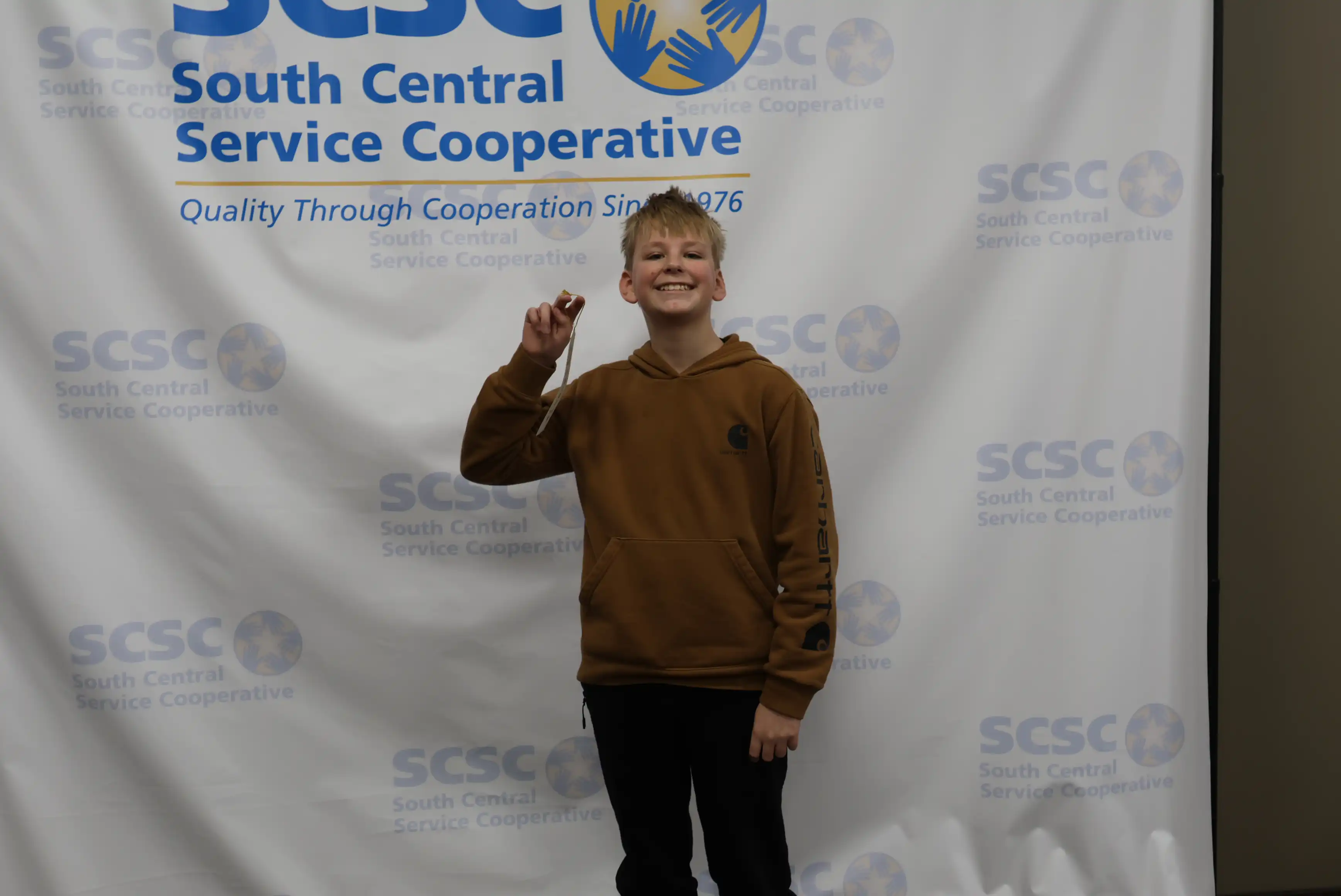 student holding up ribbon