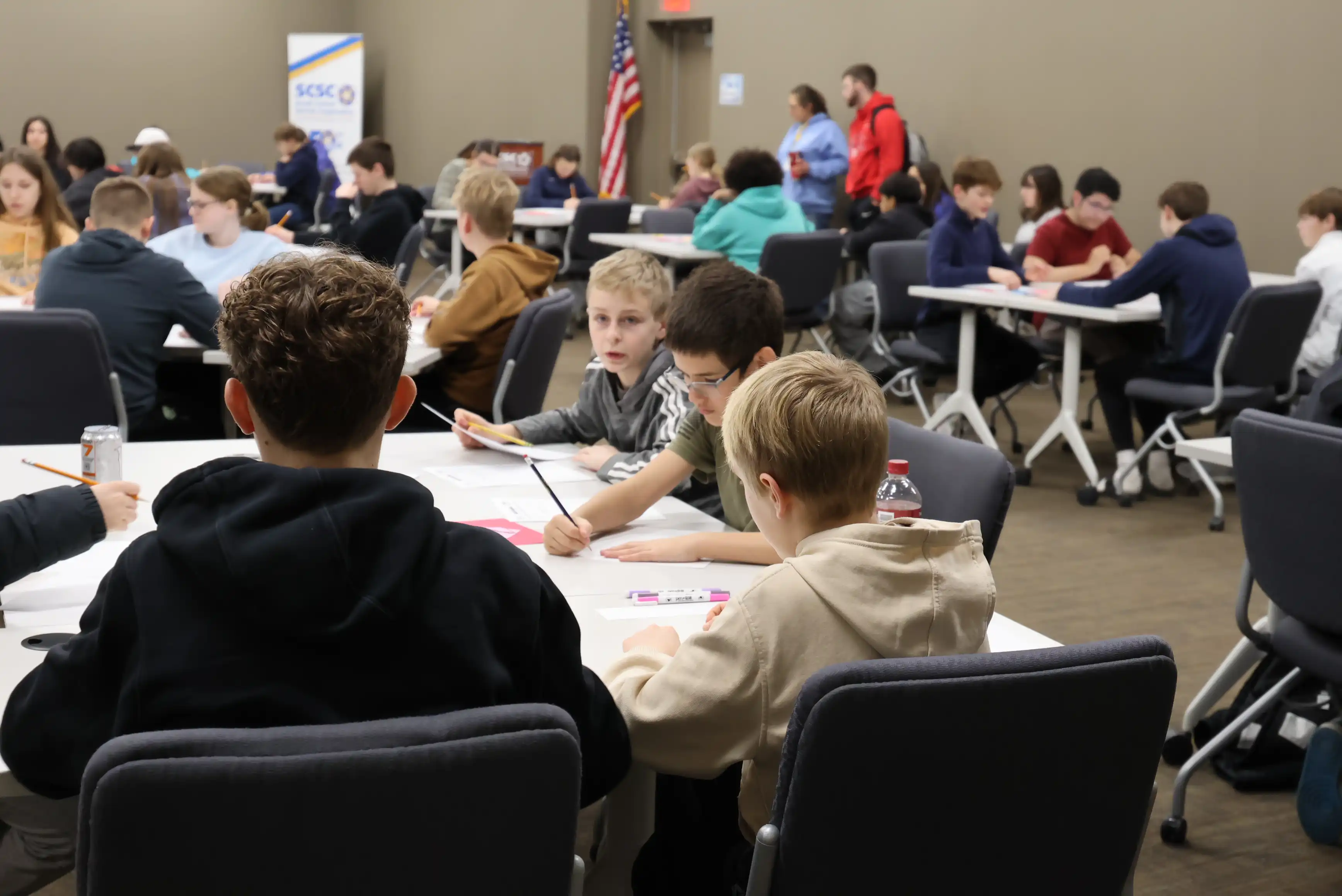 students sitting in groups at tables