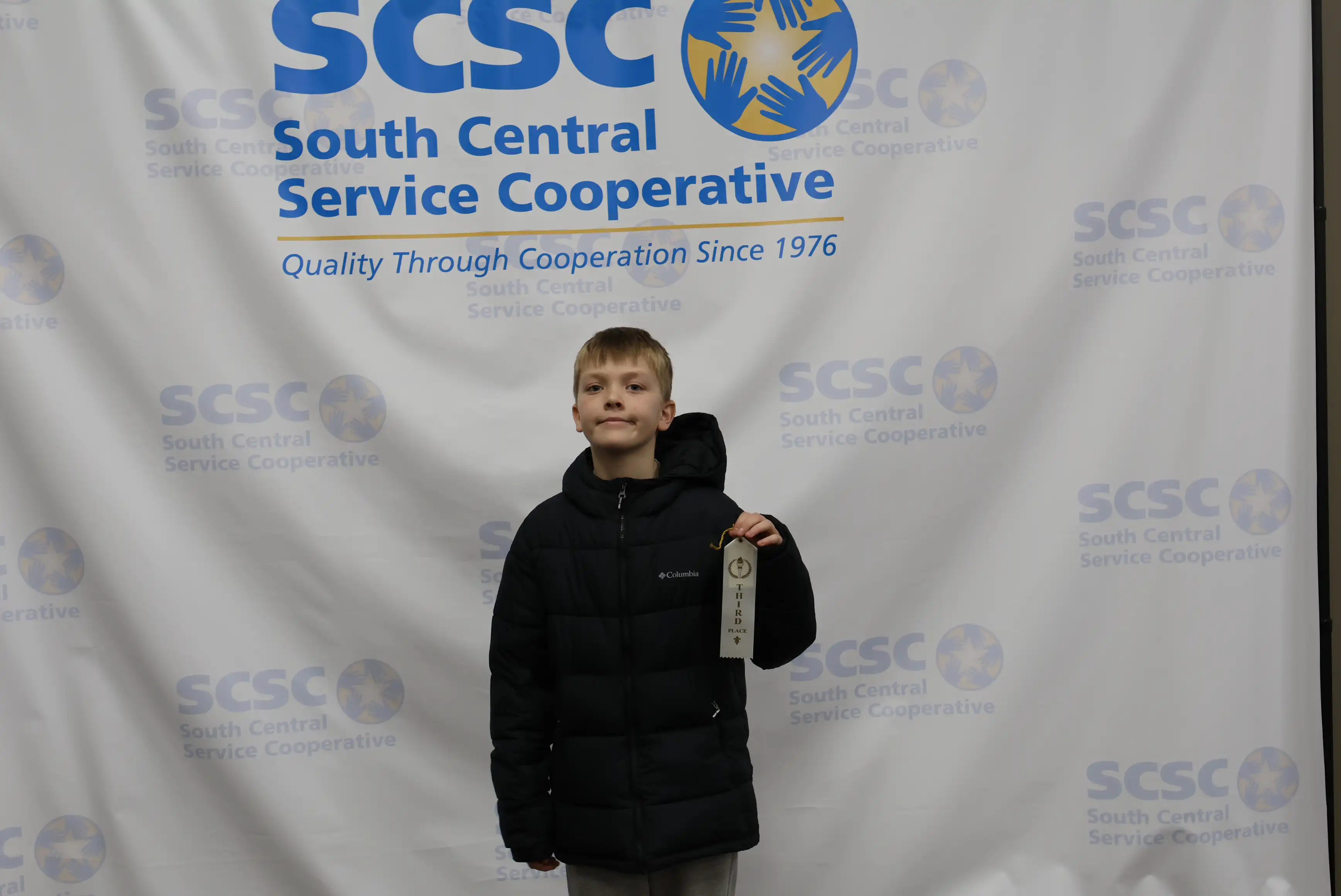student holding up ribbon