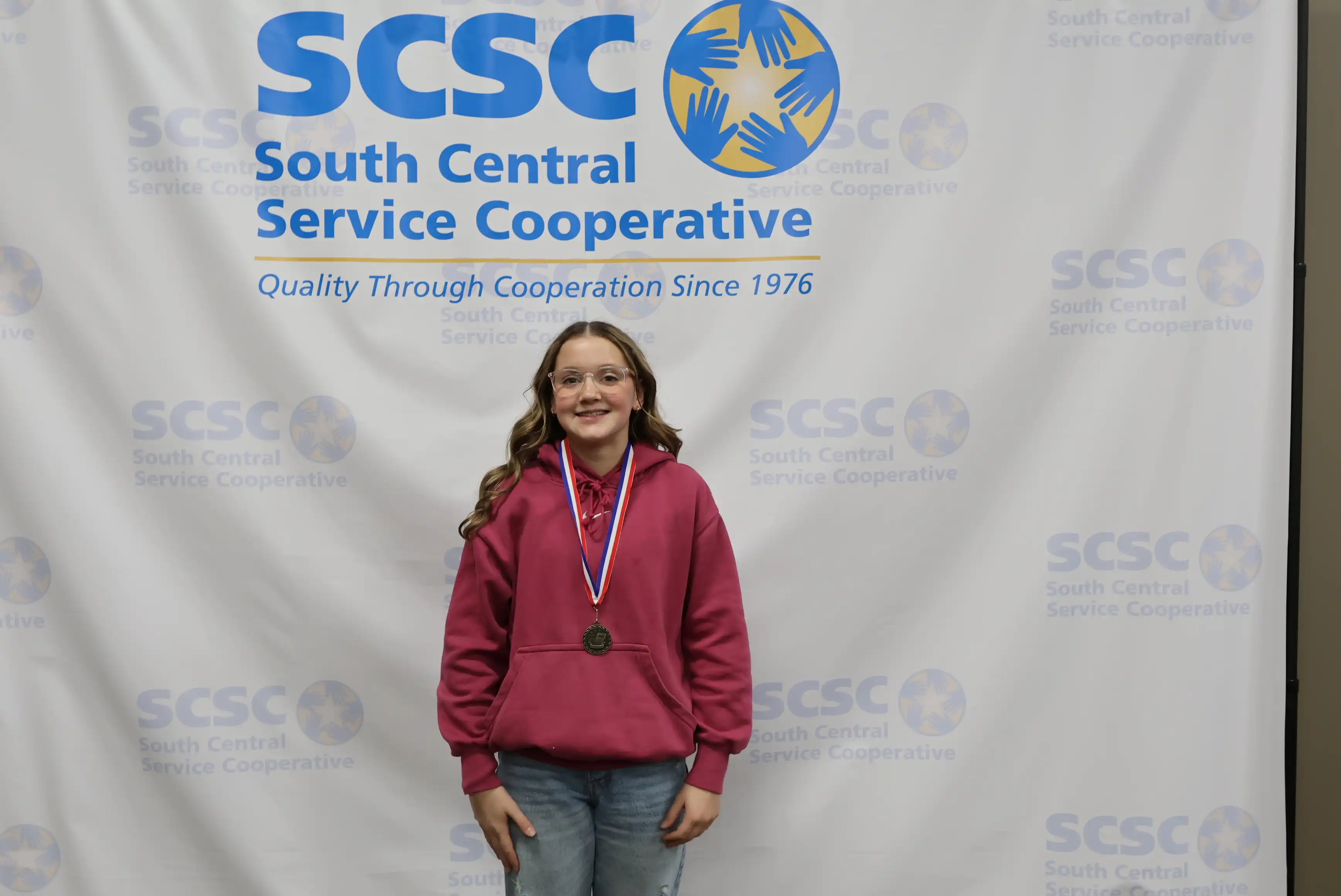 student smiling wearing a medal