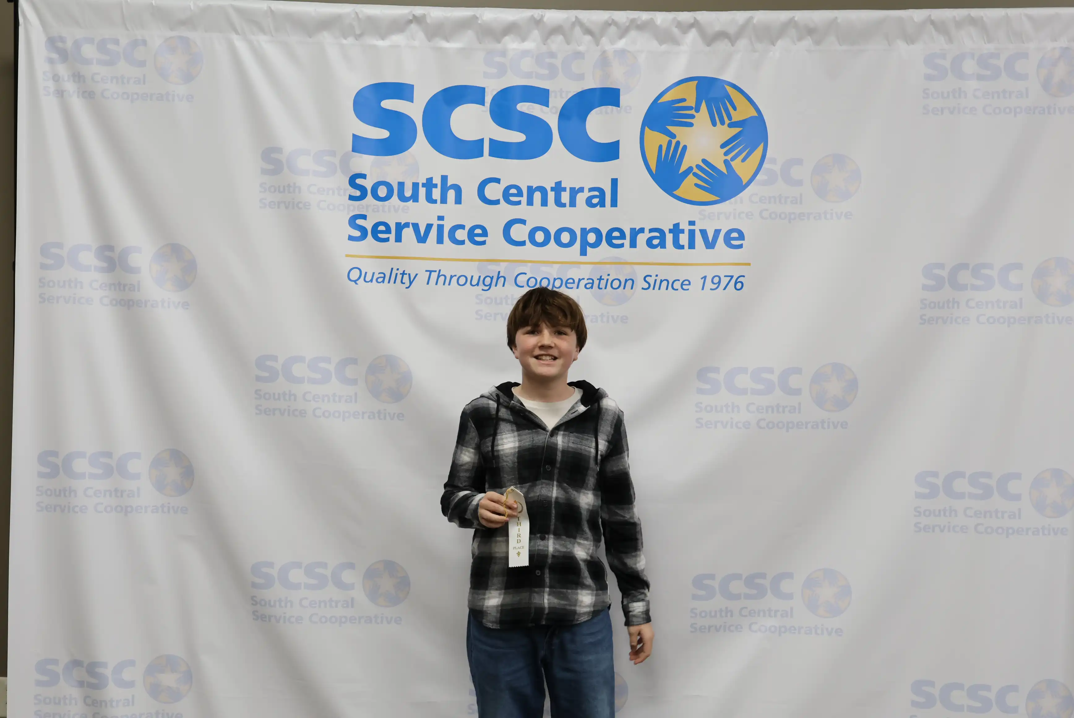 student holding up ribbon