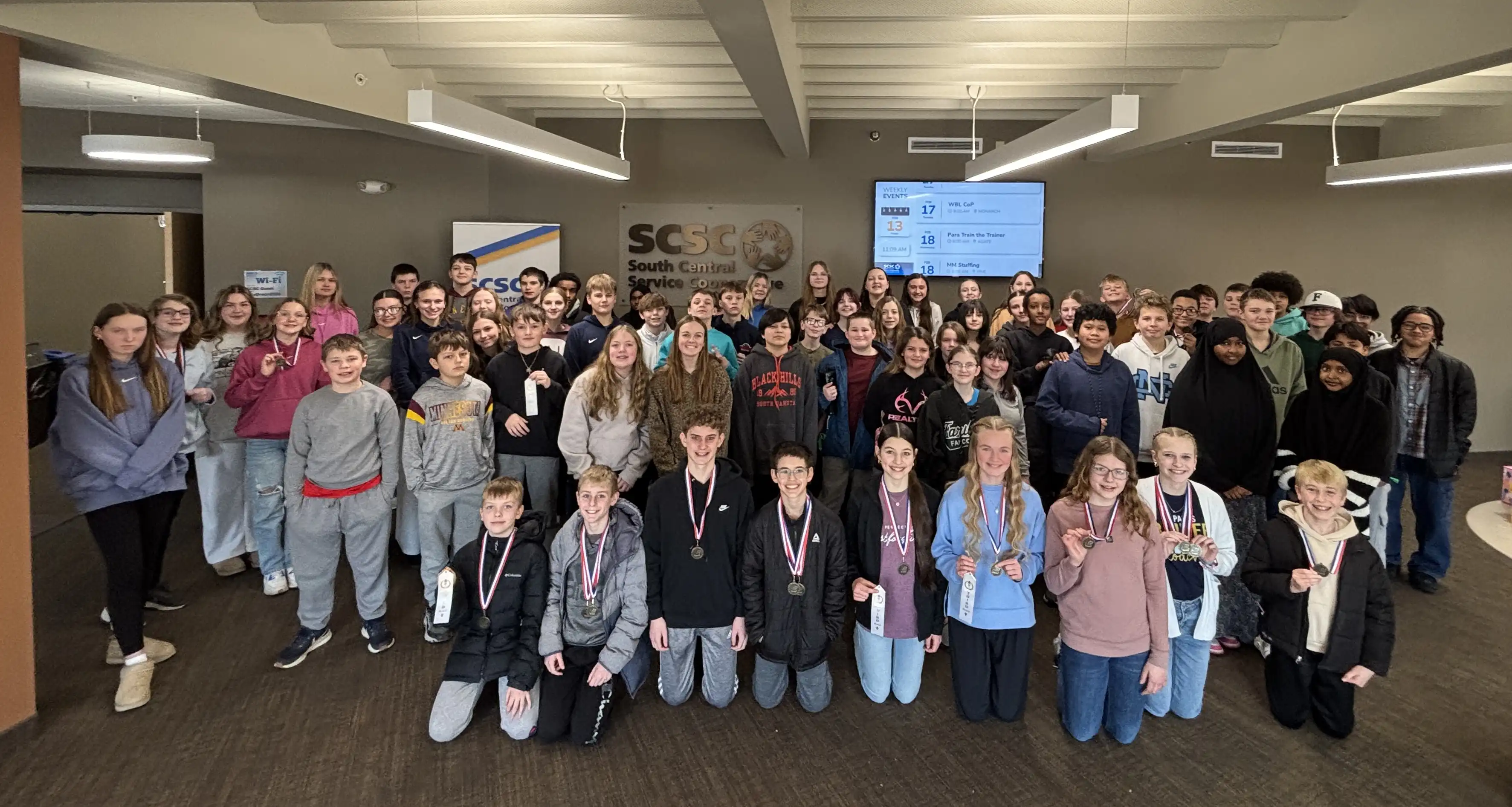 All student participants smiling for a group photo