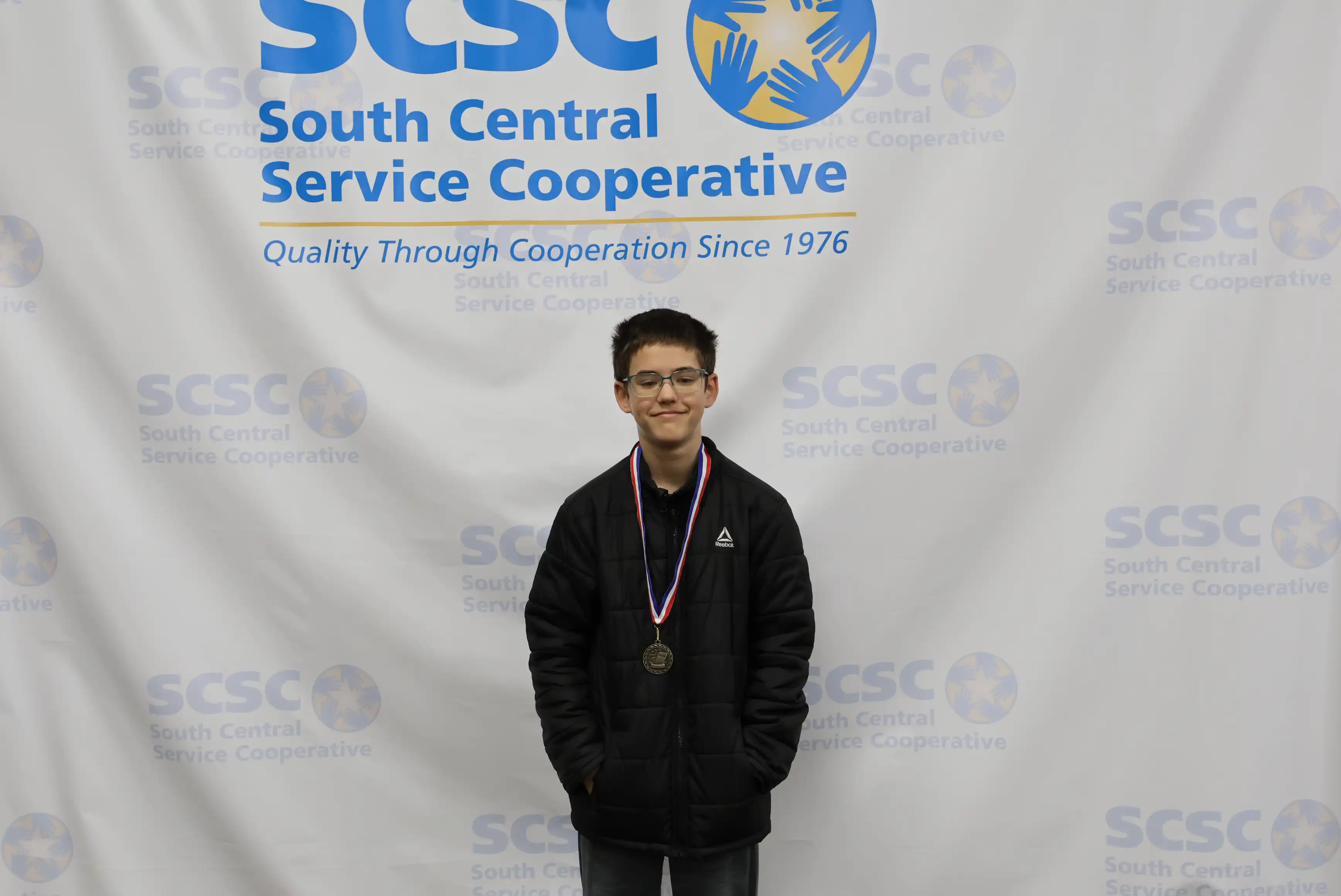 student smiling wearing a medal