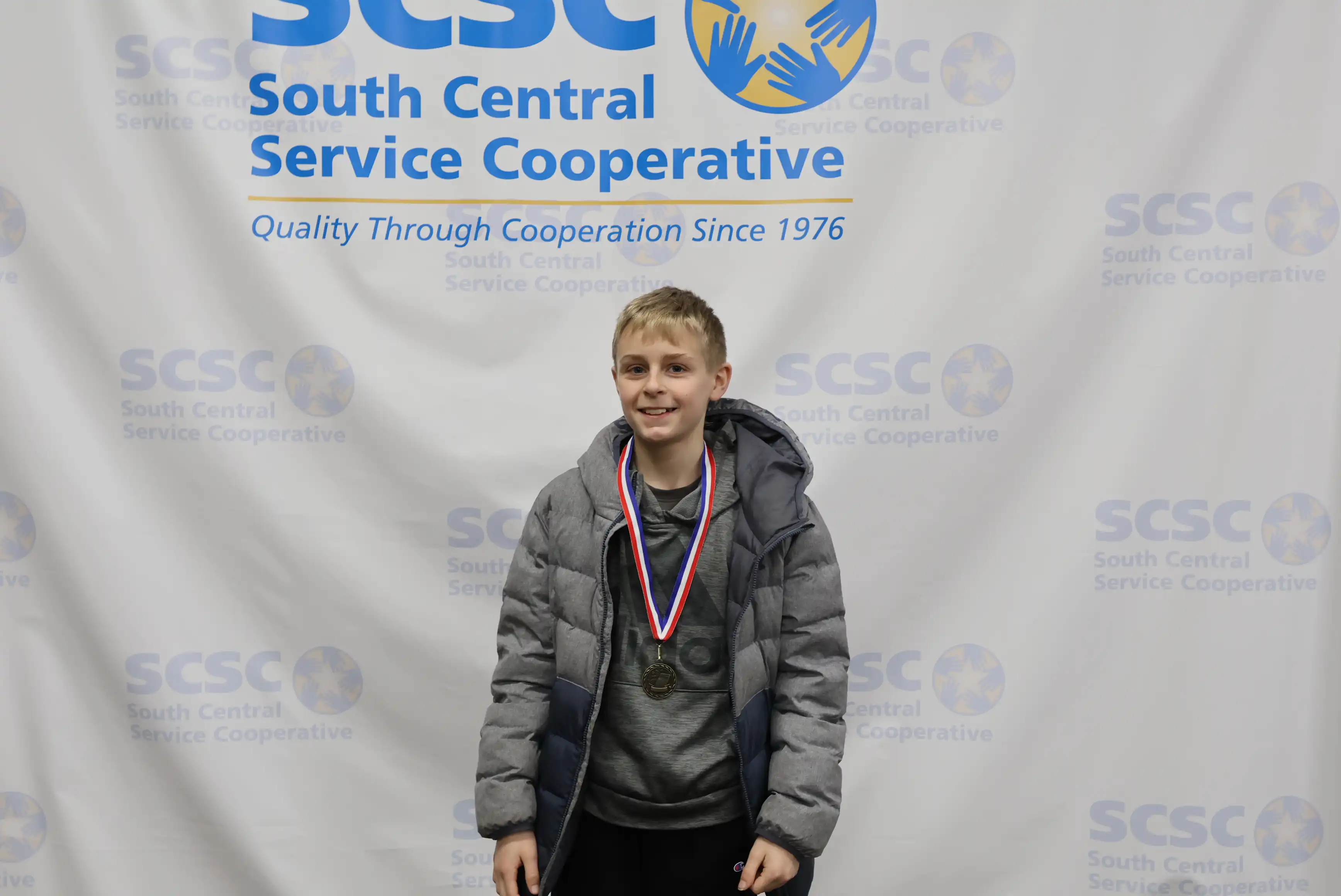 student smiling wearing a medal