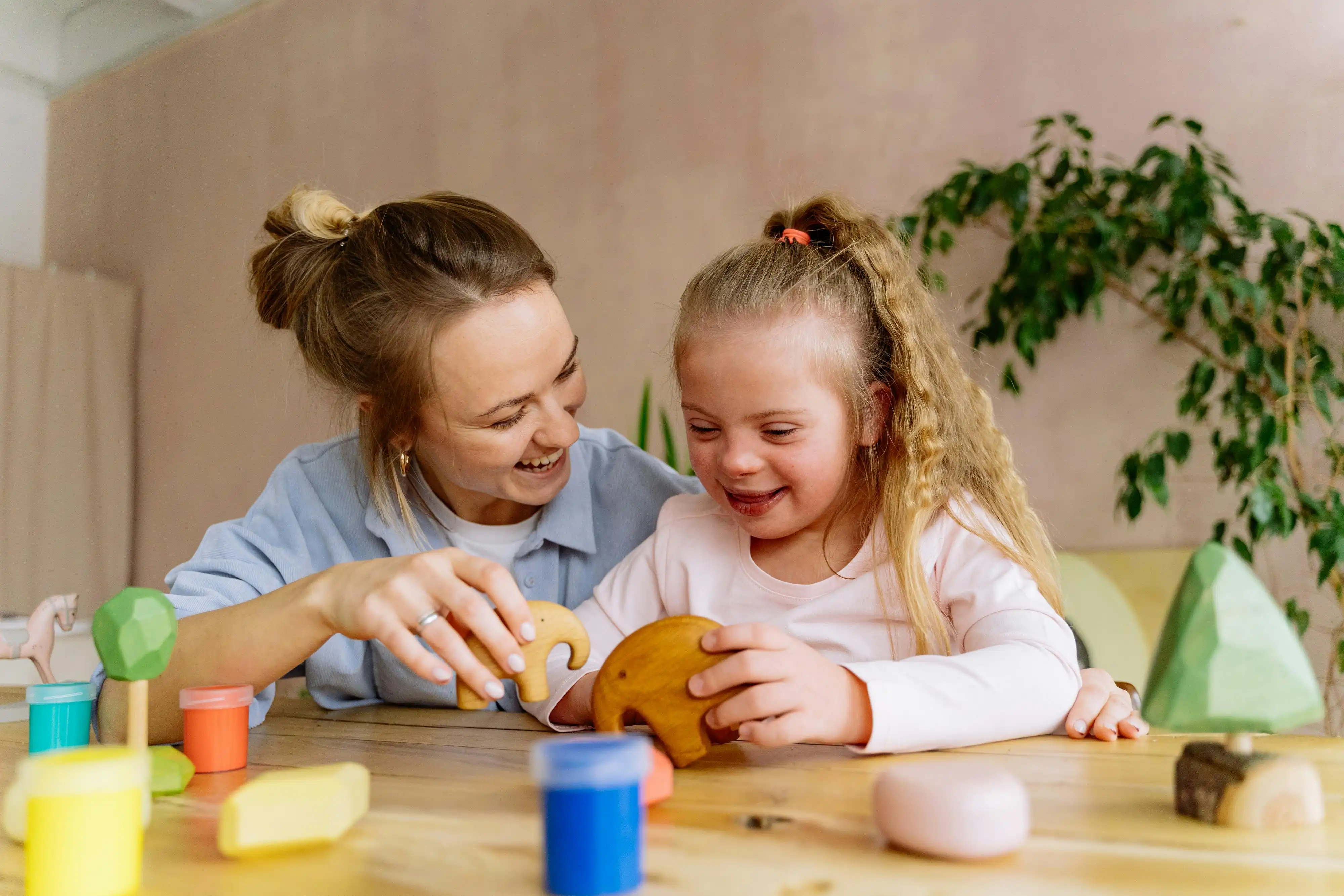 Teacher and student playing with animals blocks
