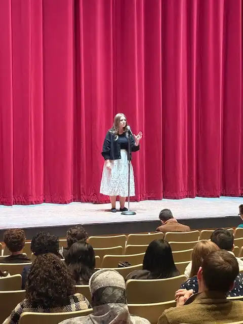 student on stage reciting their poem