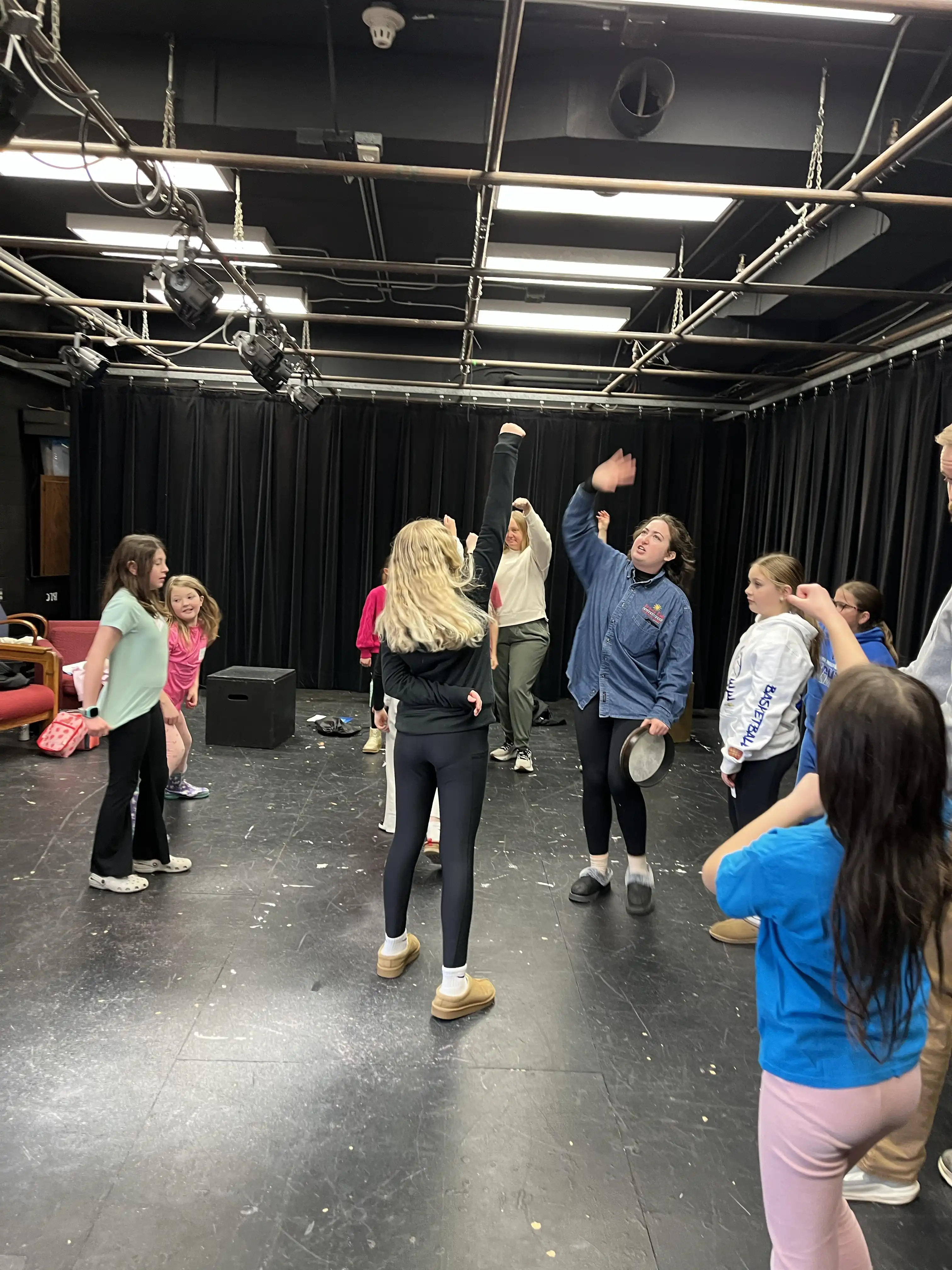 students moving around playing theatre games