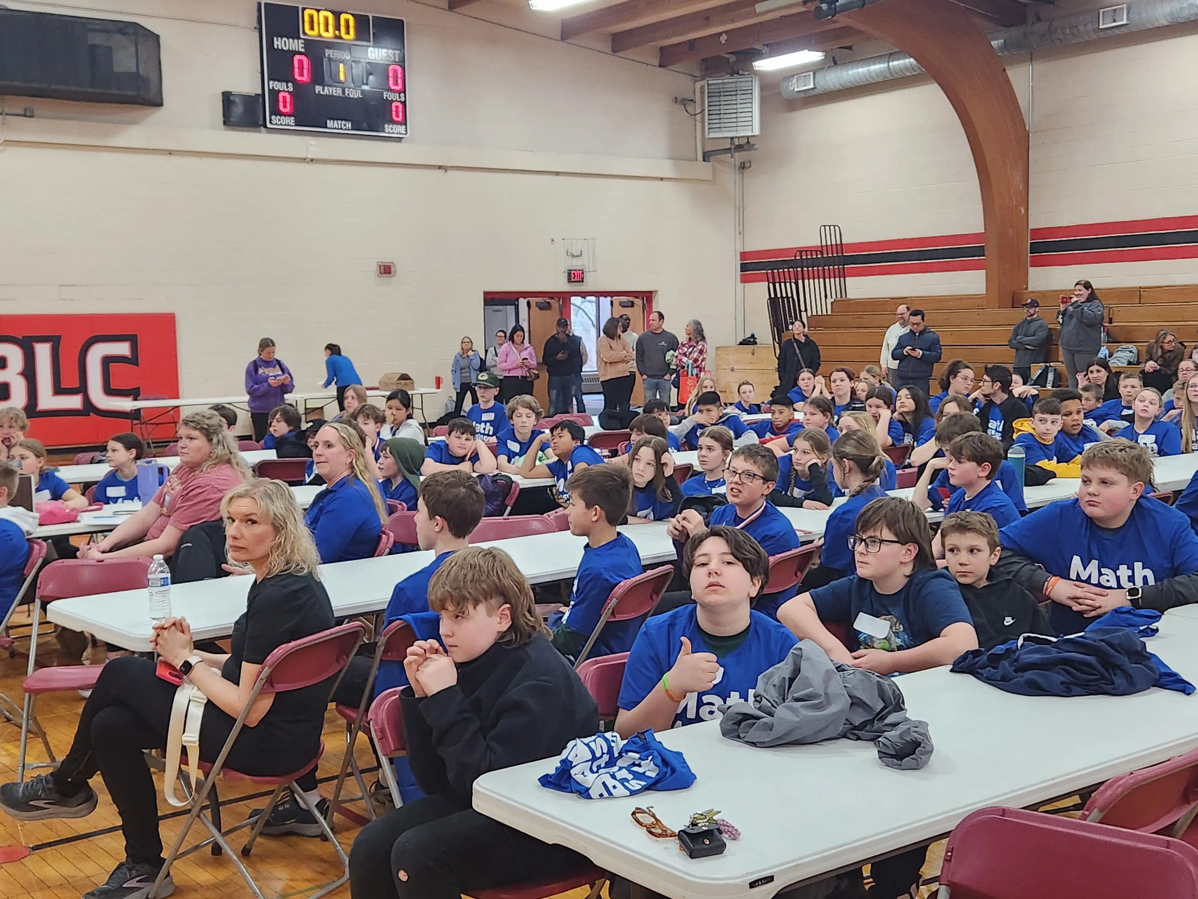 Students at many table listening to the instructions for the event 