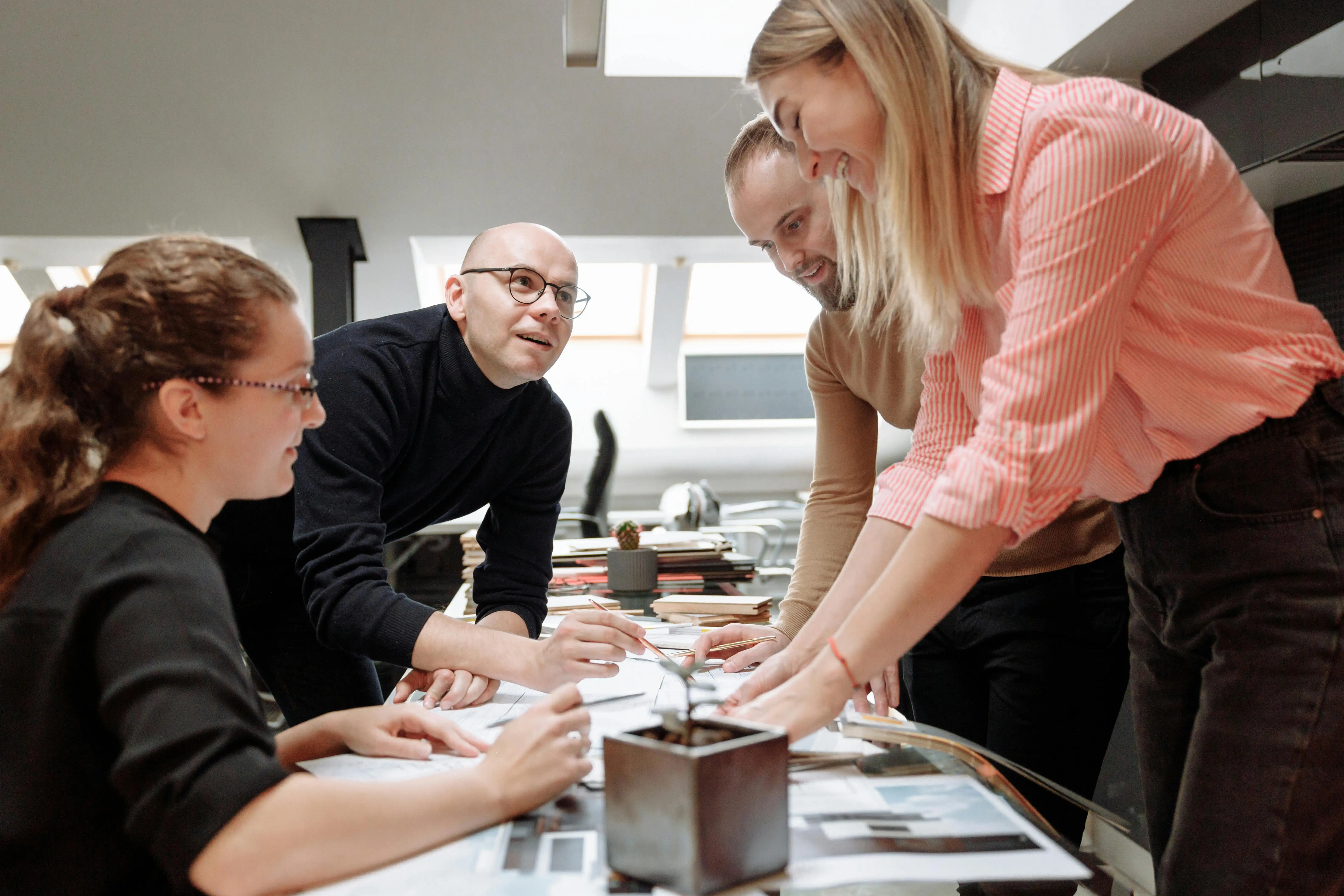Adults working together on a project around a table