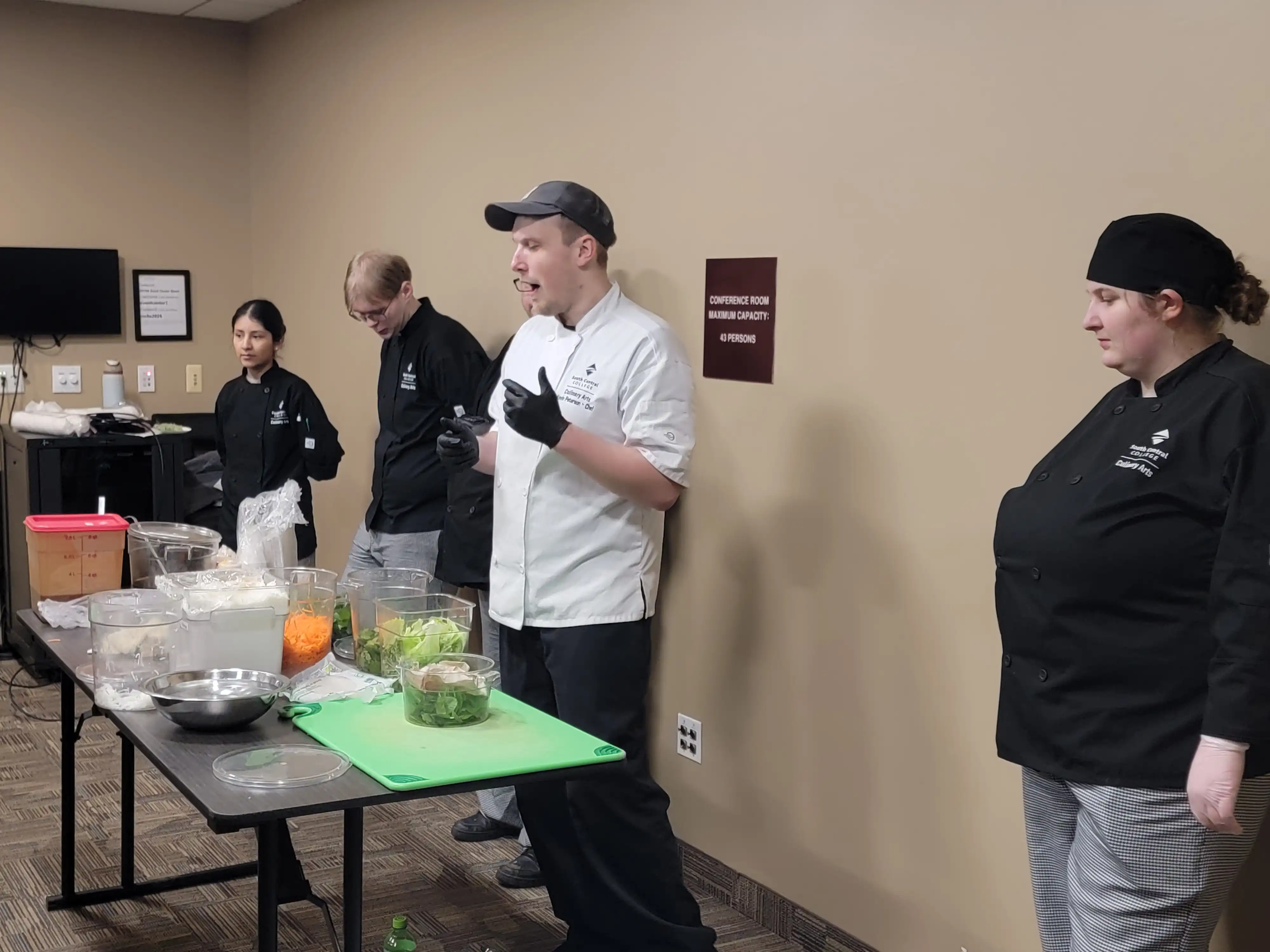 Chef in front of classroom providing instructions on next steps