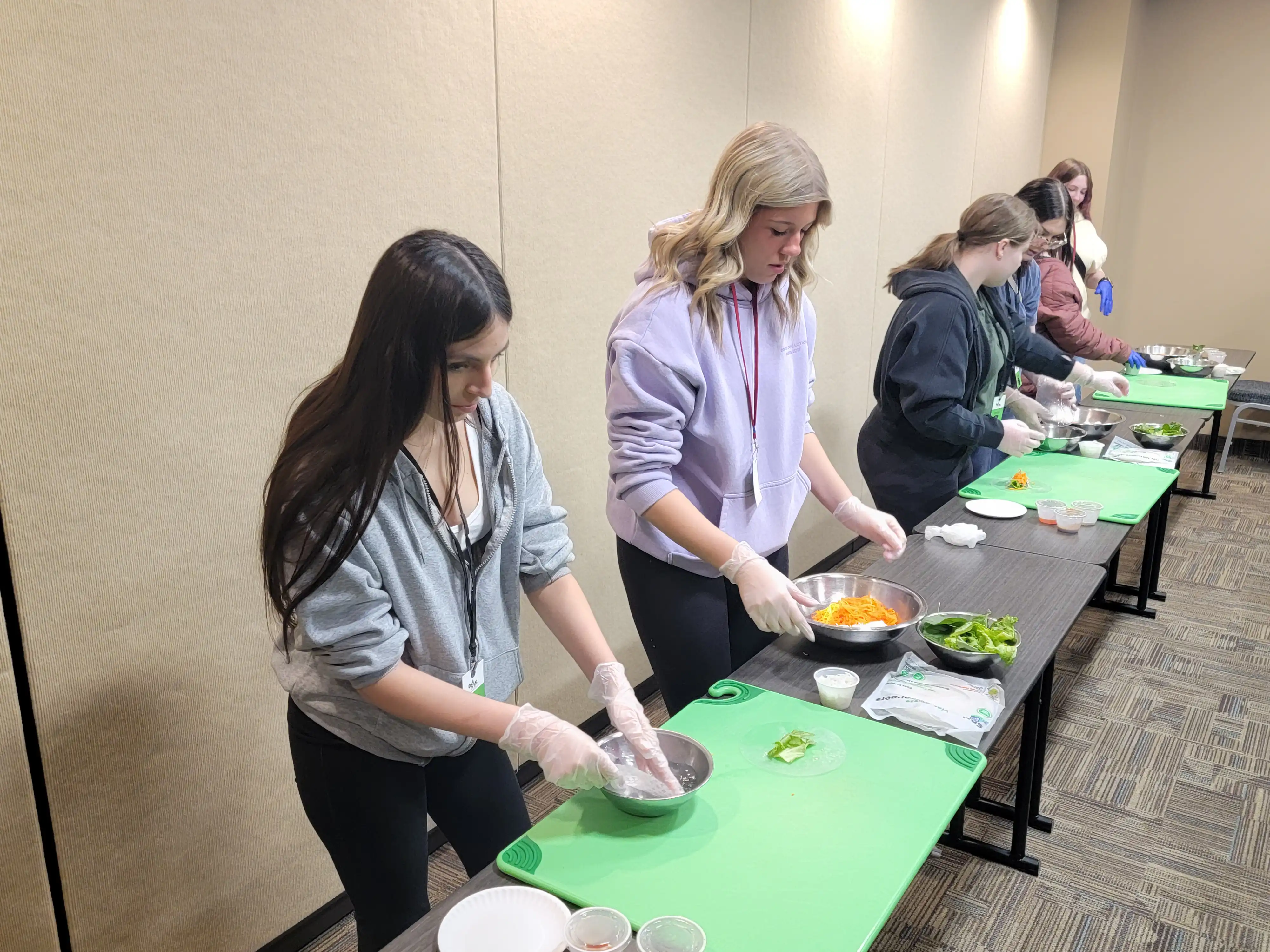 Students at a table cutting fruit and vegetables