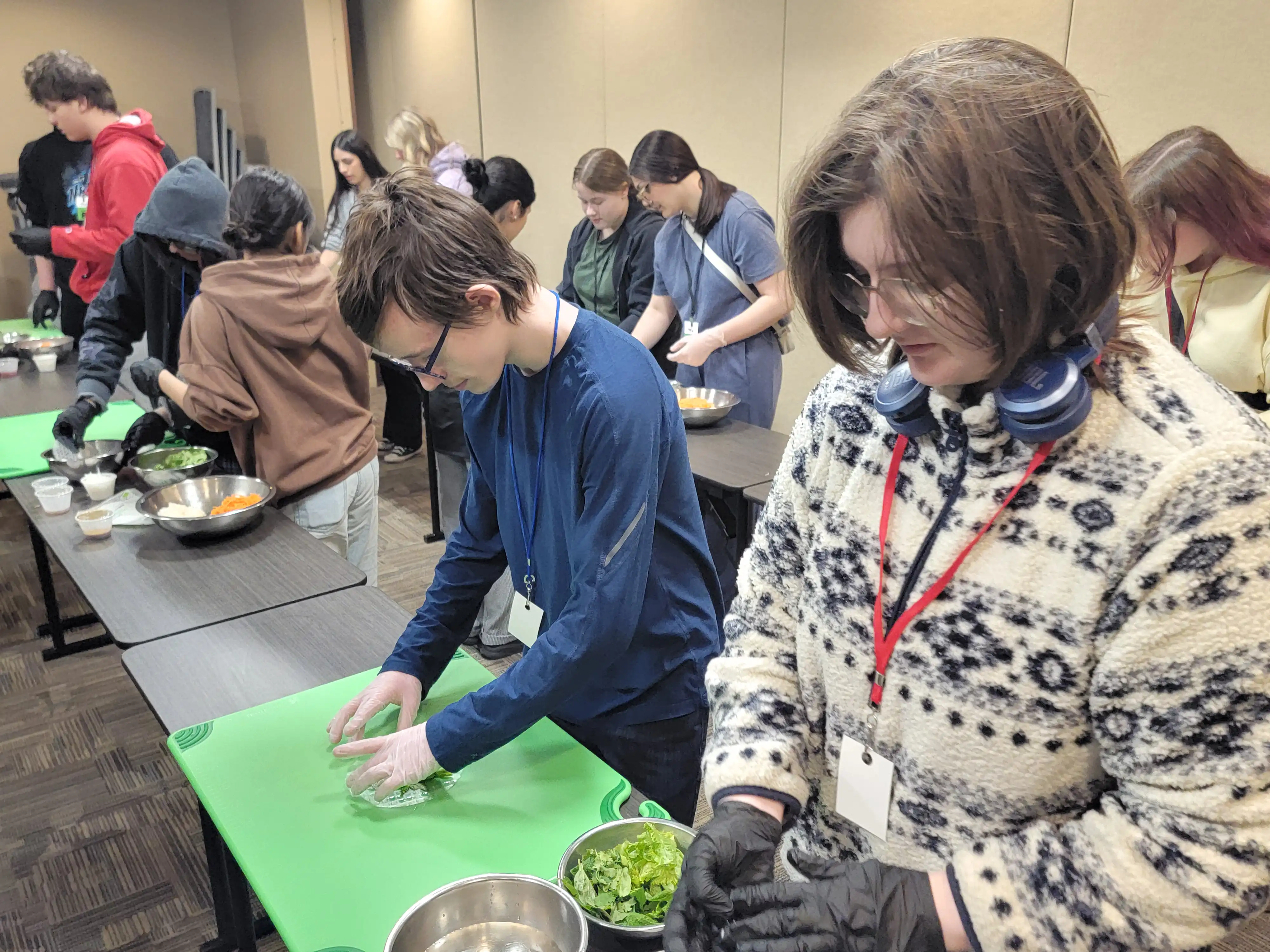 Students at tables cutting fruit