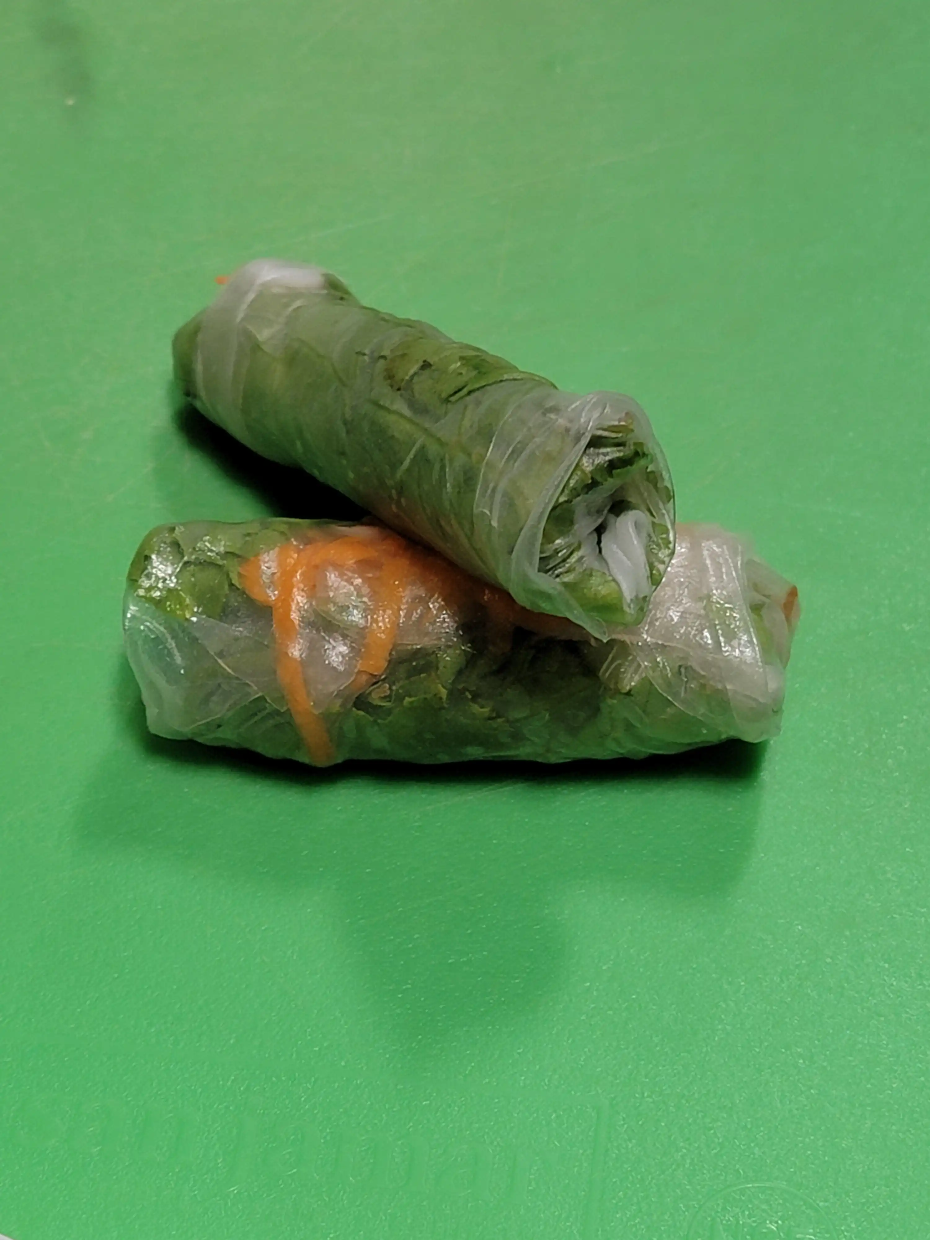 two spring rolls wrapped and place on top of each other.