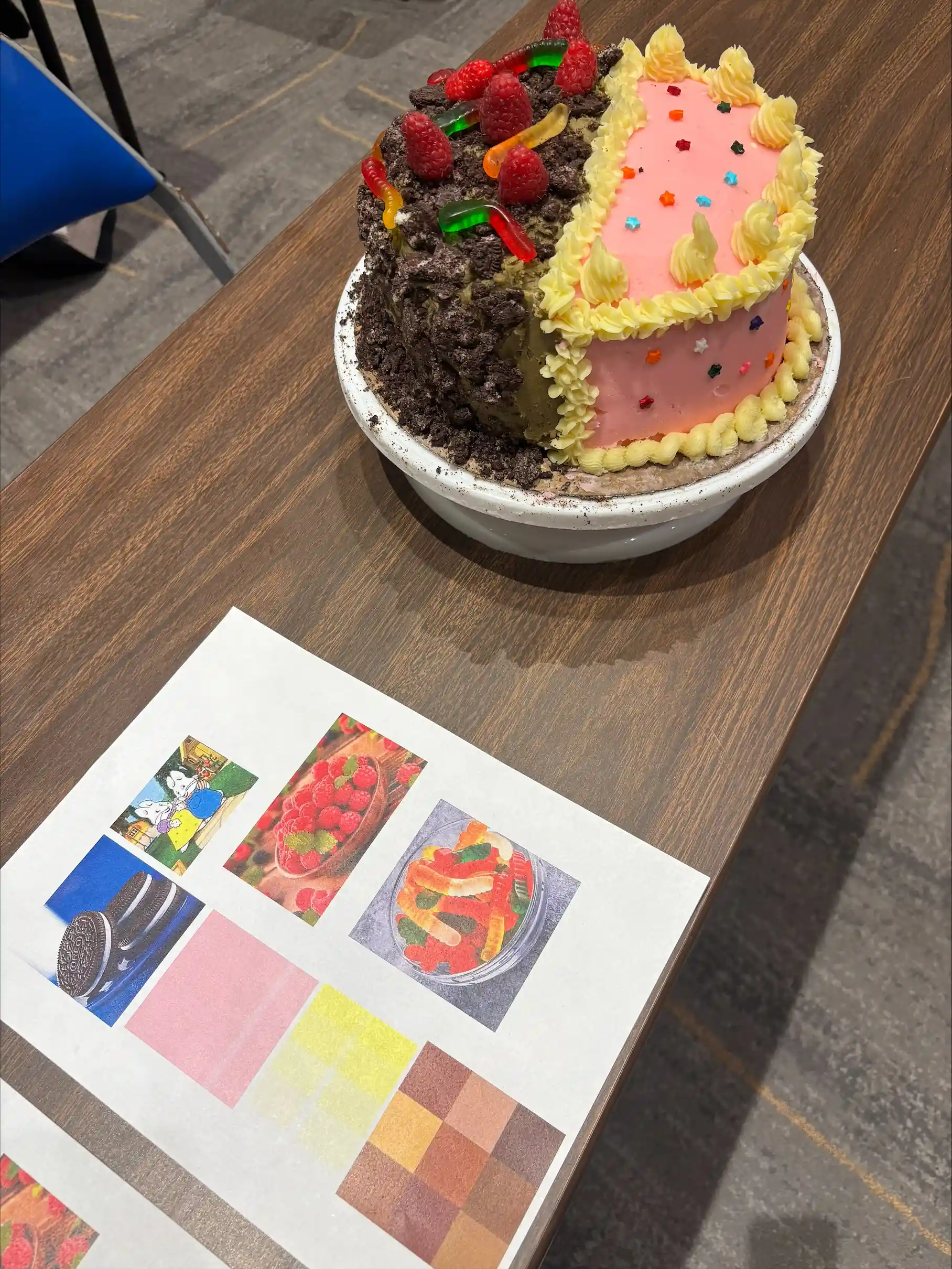 Cake with two halves decorated on with pink frosting and the other with gummy warms