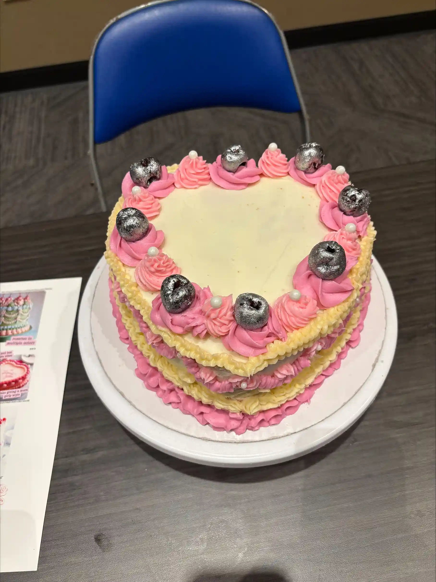 Cake decorated into a heart with pink and white frosting