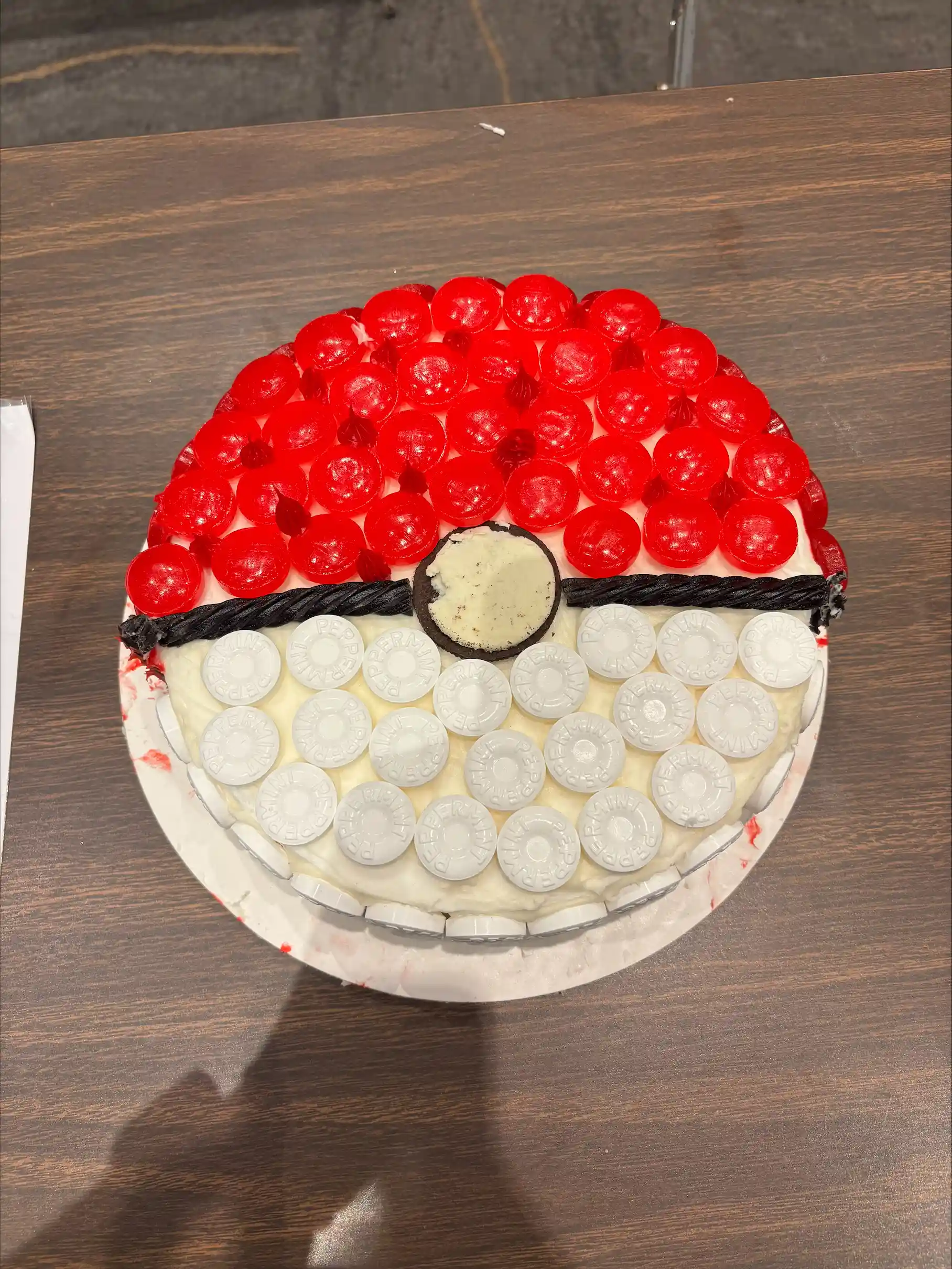 Cake decorated to look like Pokemon ball. 