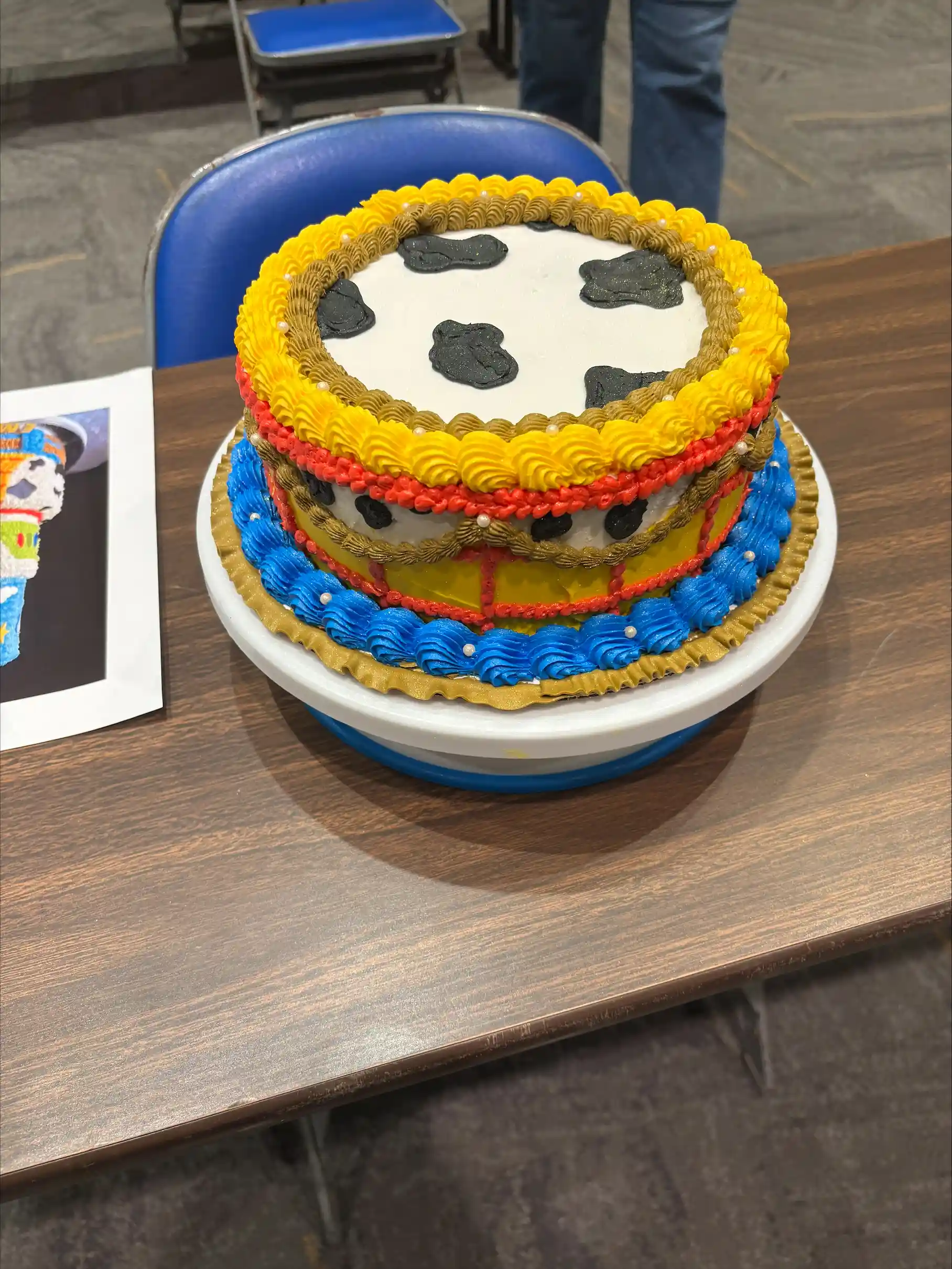 Cake decorated like a cowboy books and a cattle pattern.