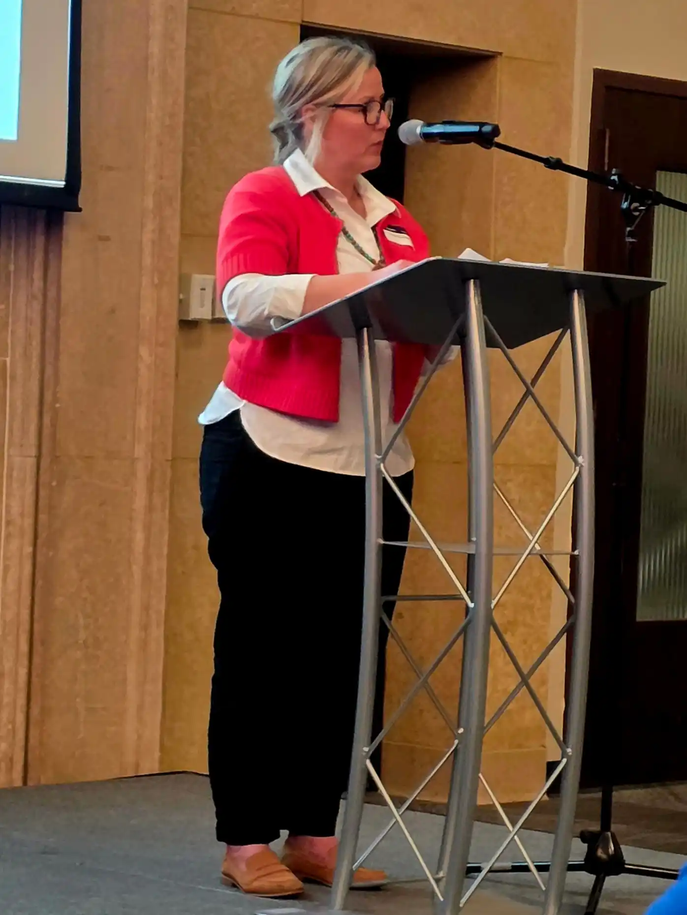 Holle Spessard speaking at the event by a podium