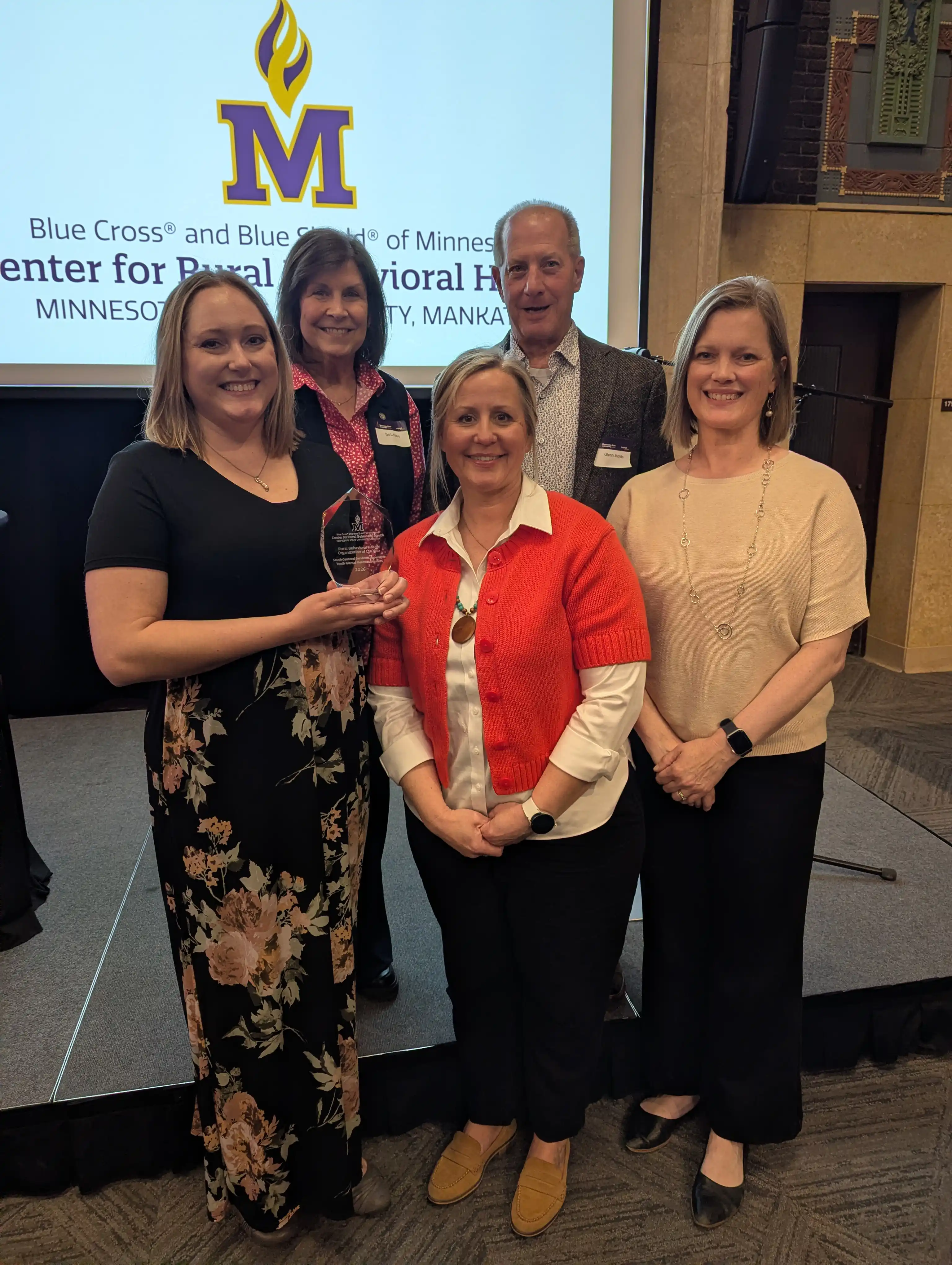 YMHN Team, SCSC CEO and Event Host smiling with their award