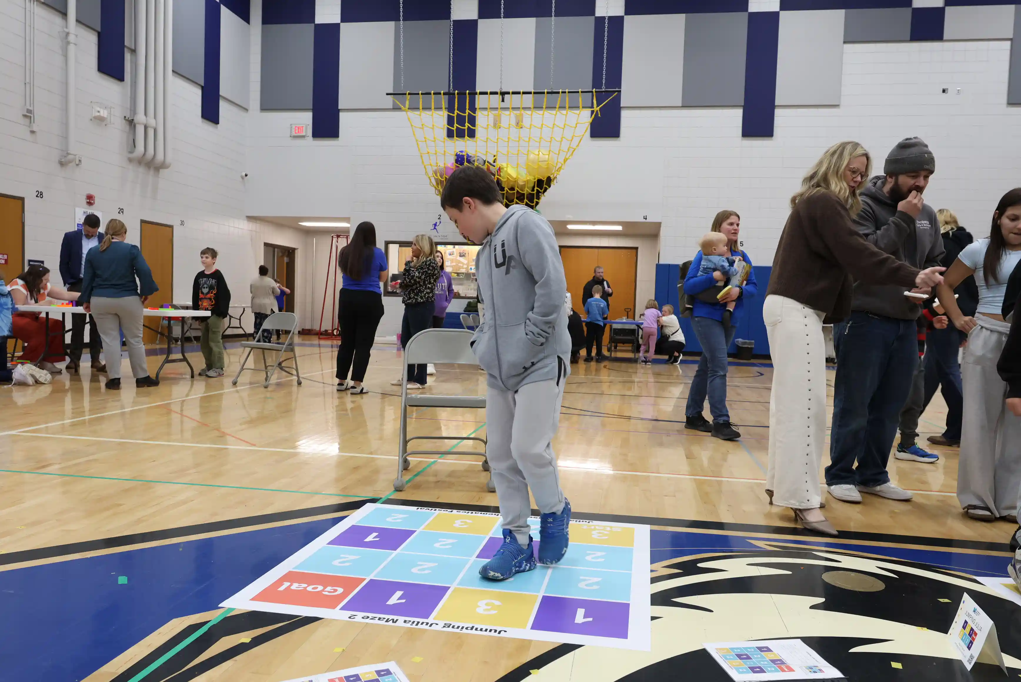 Students walking through a math chart game on the floor